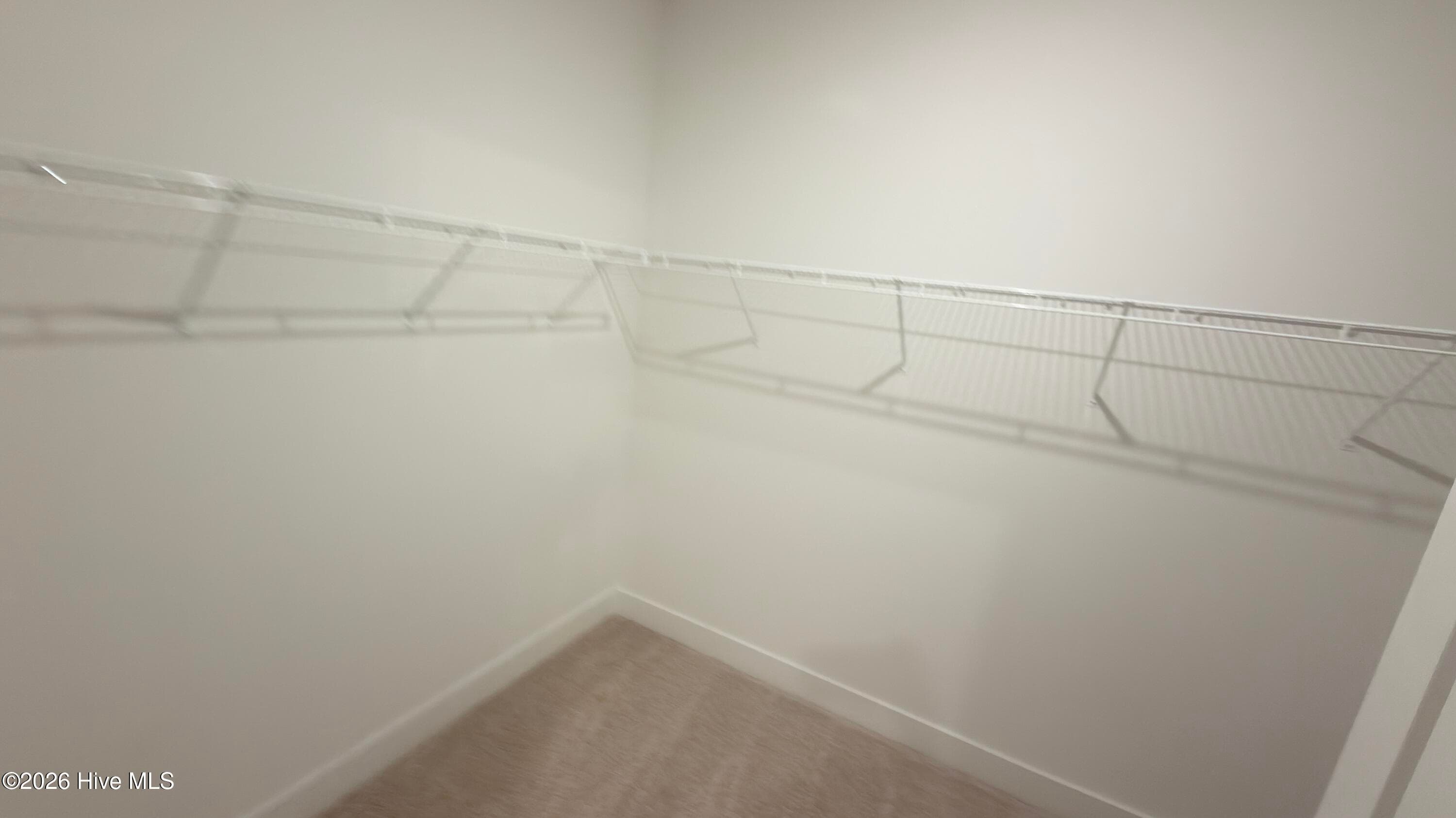 Primary walk in closet - 2129 Sandbrook Loop, Leland, NC 28451