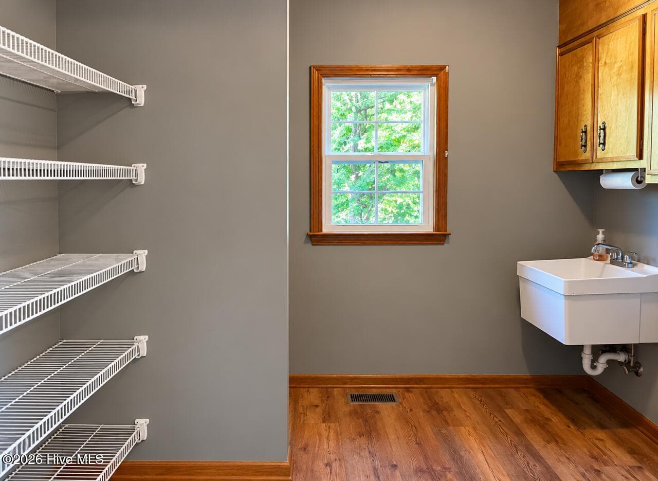 Pantry storage shelving and sink as well as new flooring in this great laundry room! - 4164 Quail Springs Circle, Augusta, GA 30907