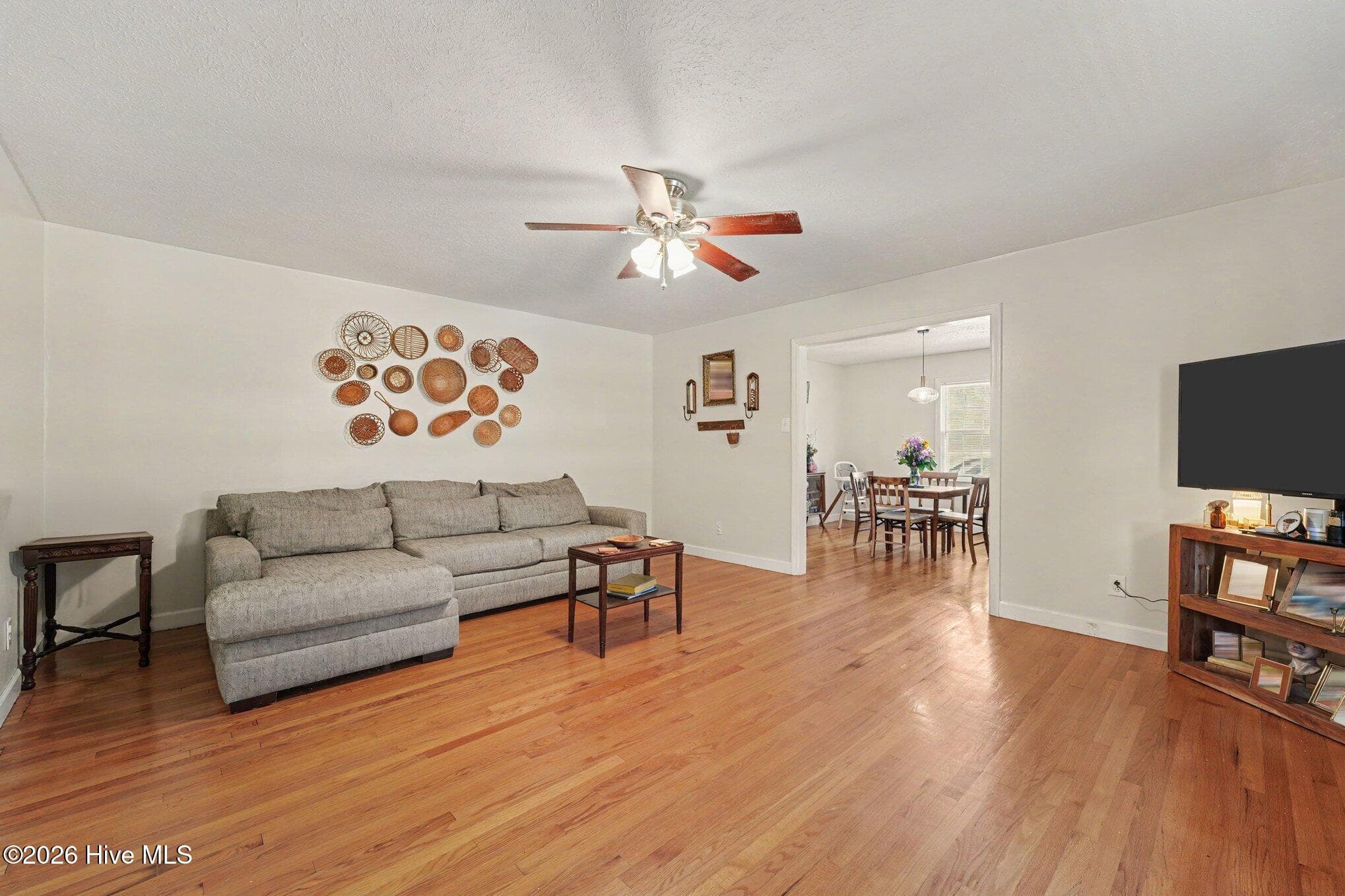 Large living room with ceiling fan and hardwood - 1017 S Claiborne Street, Goldsboro, NC 27530