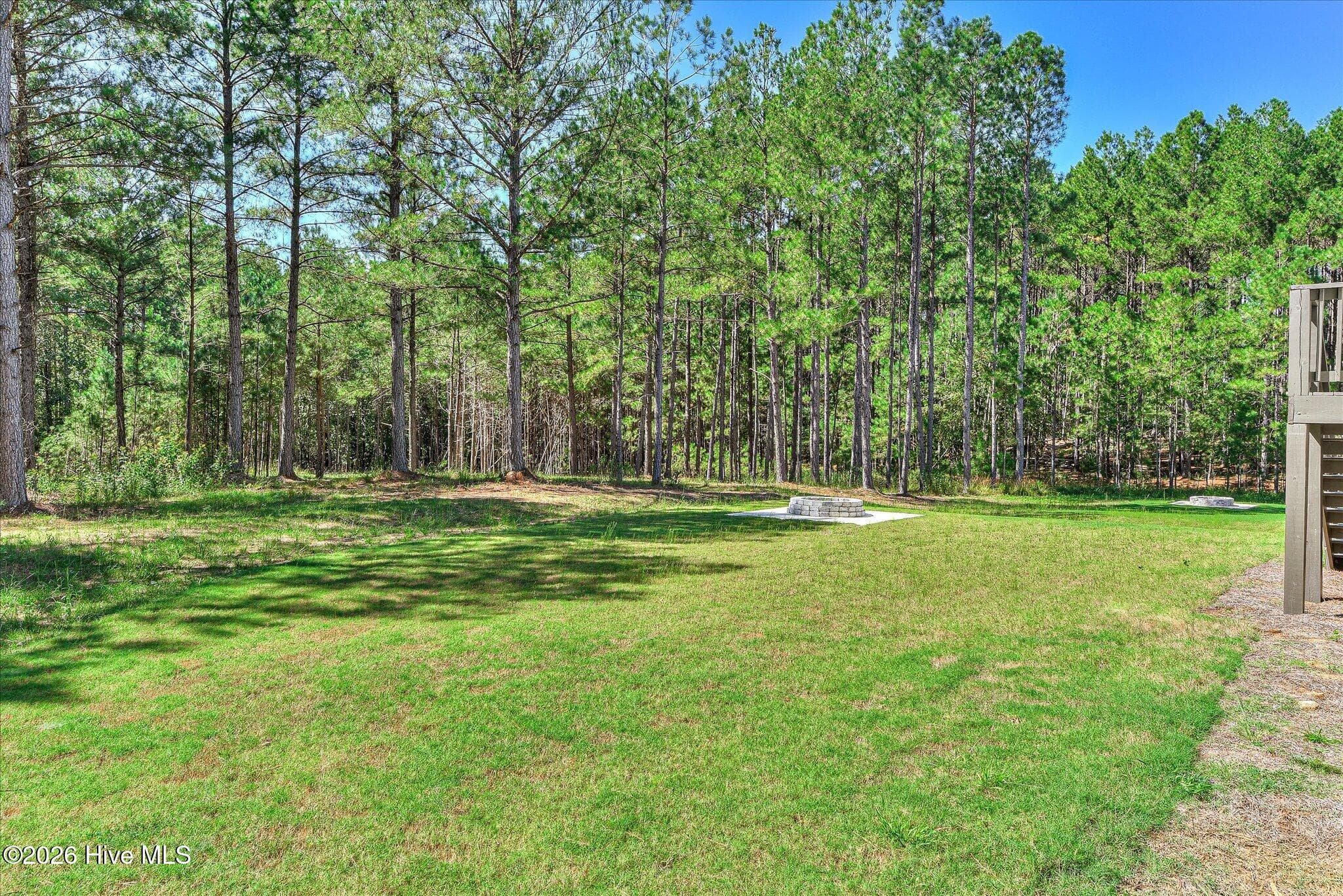Large backyard with fire pit and trail to the lake, lot is dockable when water levels return to normal. - 1198 Sunset Cove, Tignall, GA 30668