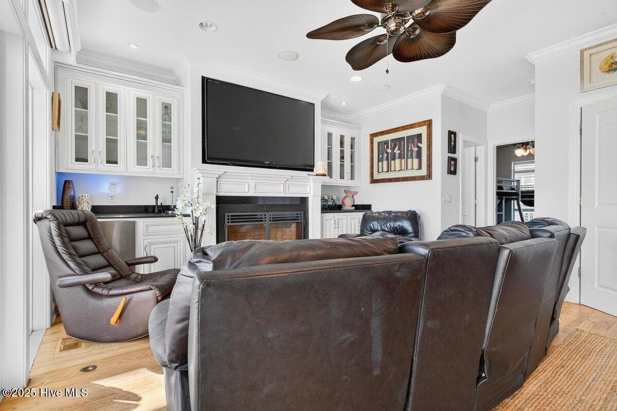 Theater room with recliners and 70" TV mounted over fireplace - 7 Coggeshall Drive W, Ocean Isle Beach, NC 28469