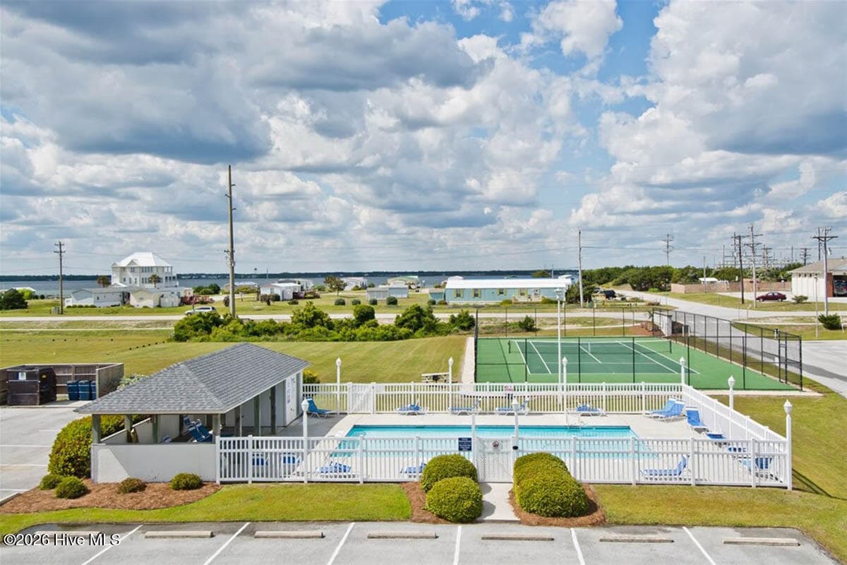 Pier Pointe West offers excellent amenities including two outdoor swimming pools, a tennis court, electric vehicle charging station, and private beach access. The HOA dues include water, cable, and internet, providing added convenience for owners and guests. - 2909 Pointe West Drive 3b1, Emerald Isle, NC 28594