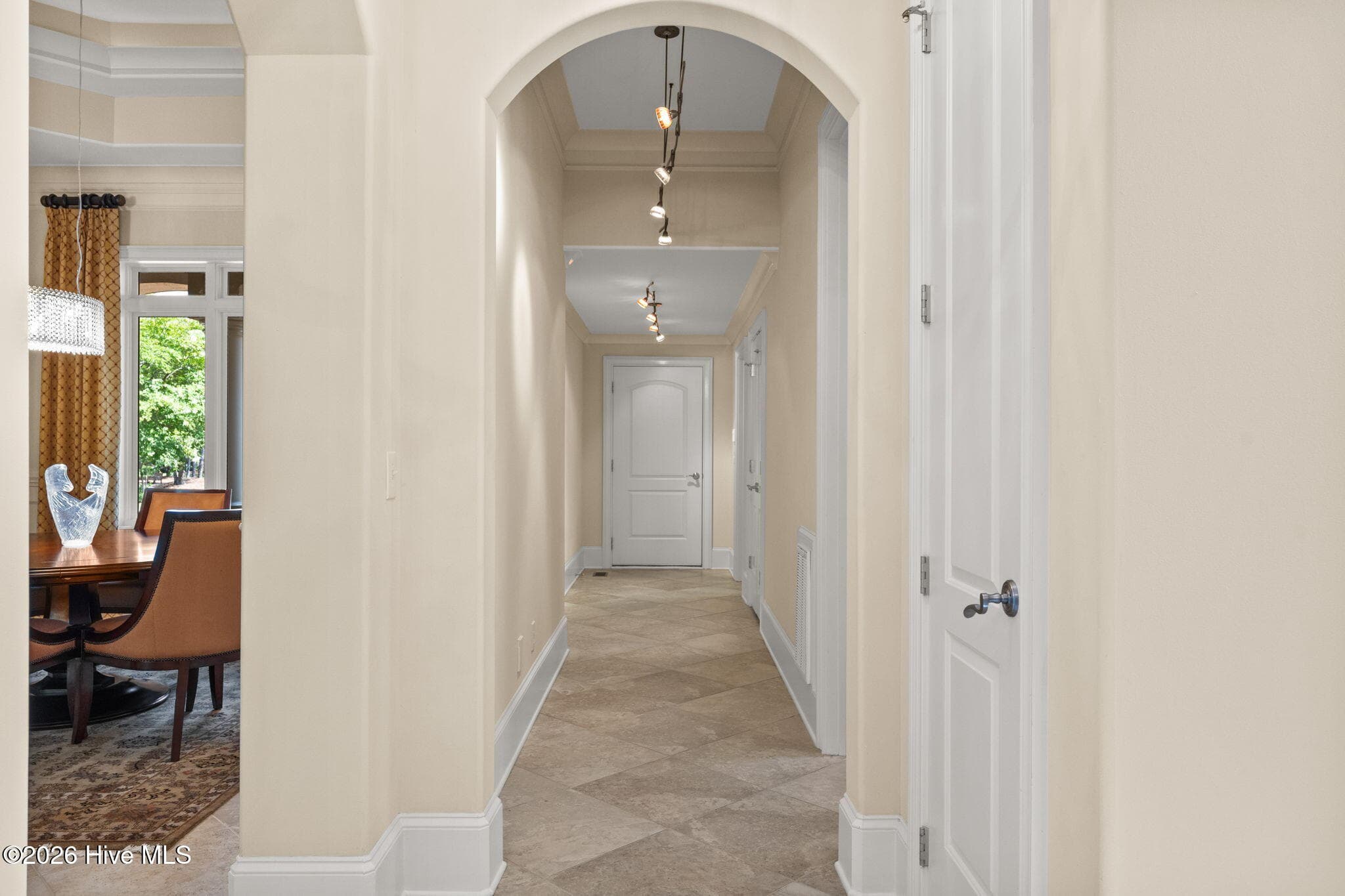 Hallway leads to first floor guest room, laundry room and 2 car garage. - 3858 Ridge Crest Drive, Southport, NC 28461