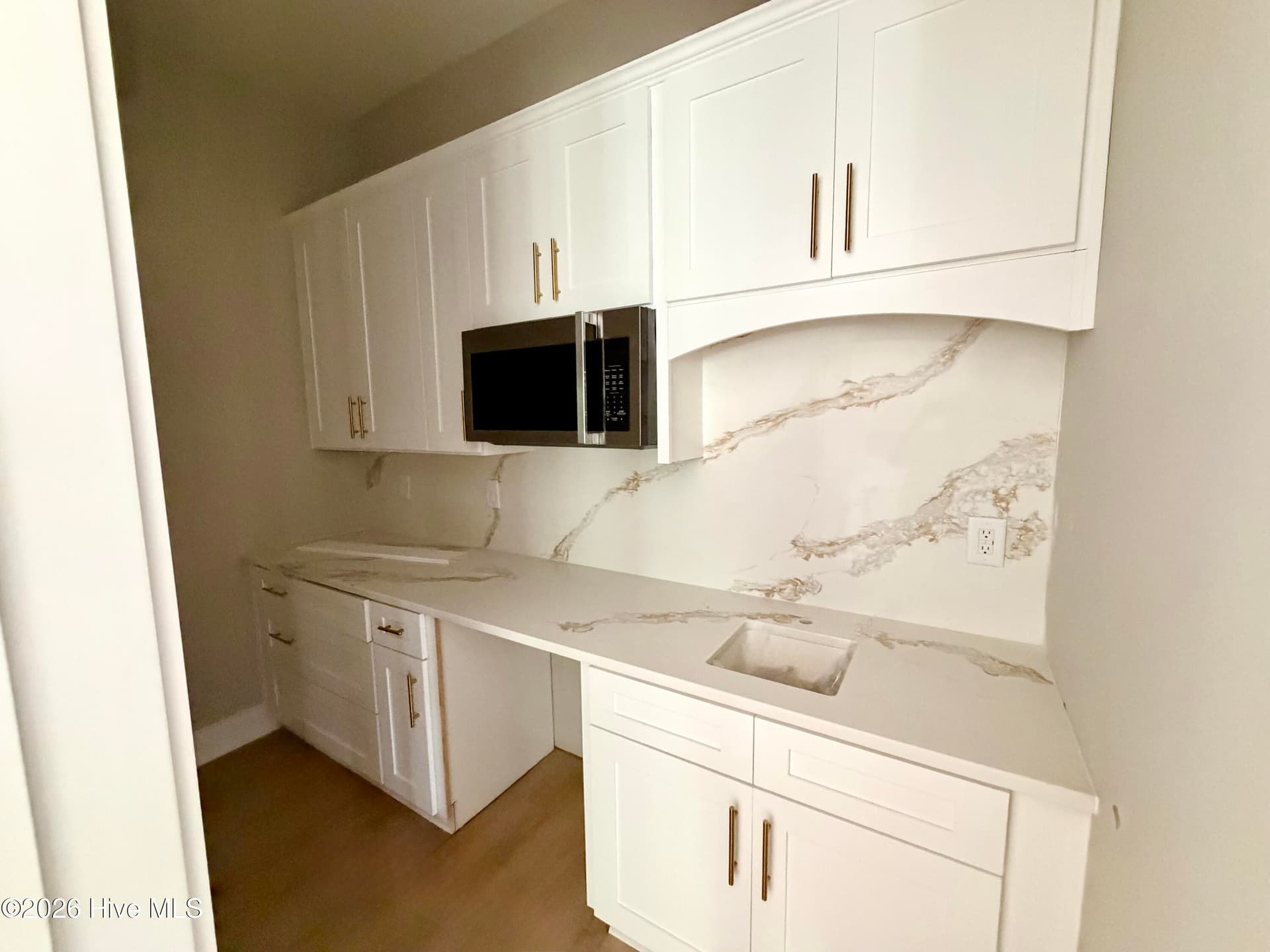 Butler's pantry with custom counters, backsplash, cabinet pulls, under construction. Wine fridge to be installed. - 550 Glenburnie Street NW, Calabash, NC 28467