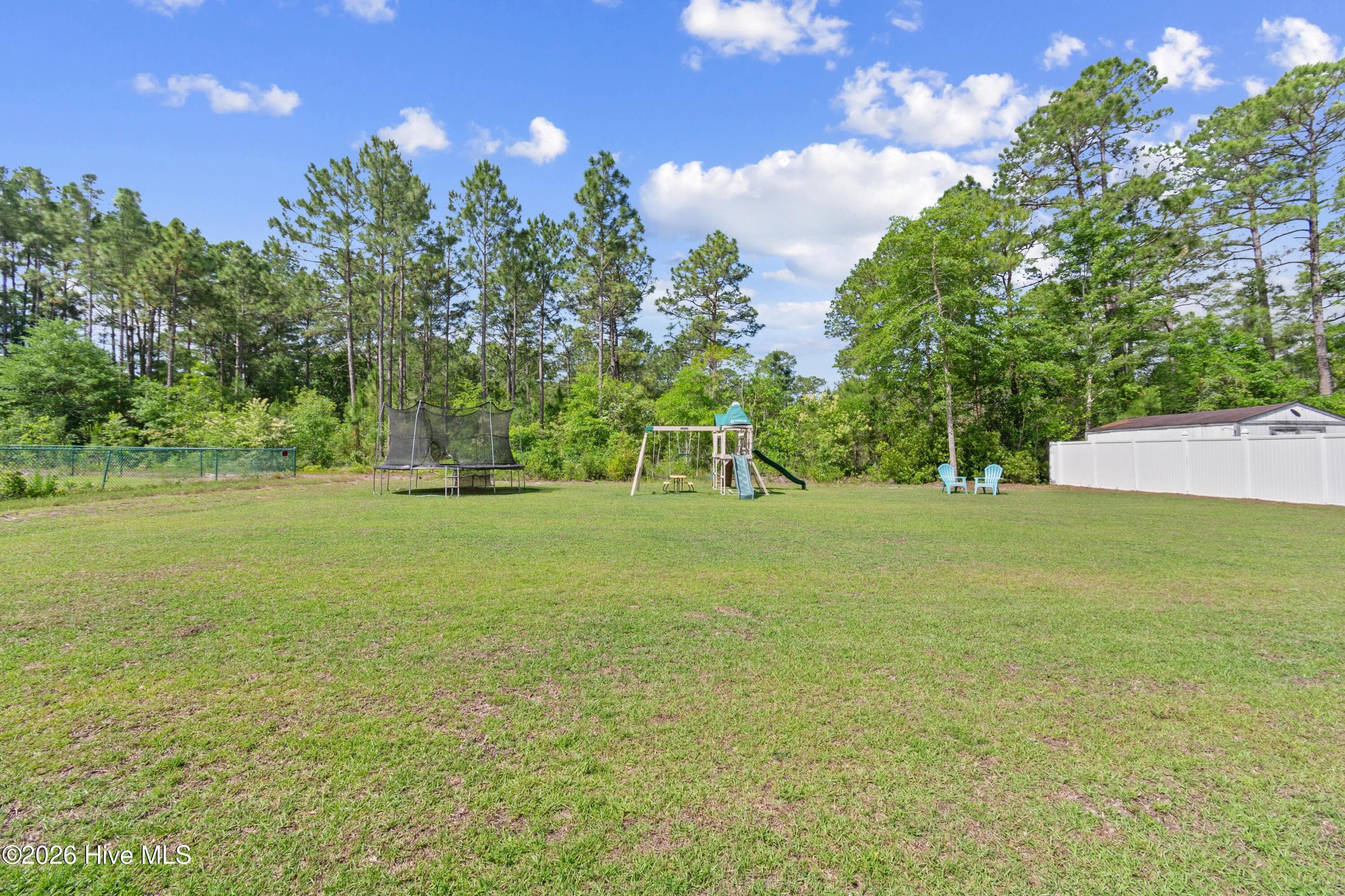 View of the rear yard from the dining area - 299 Boundaryline Drive NW, Calabash, NC 28467