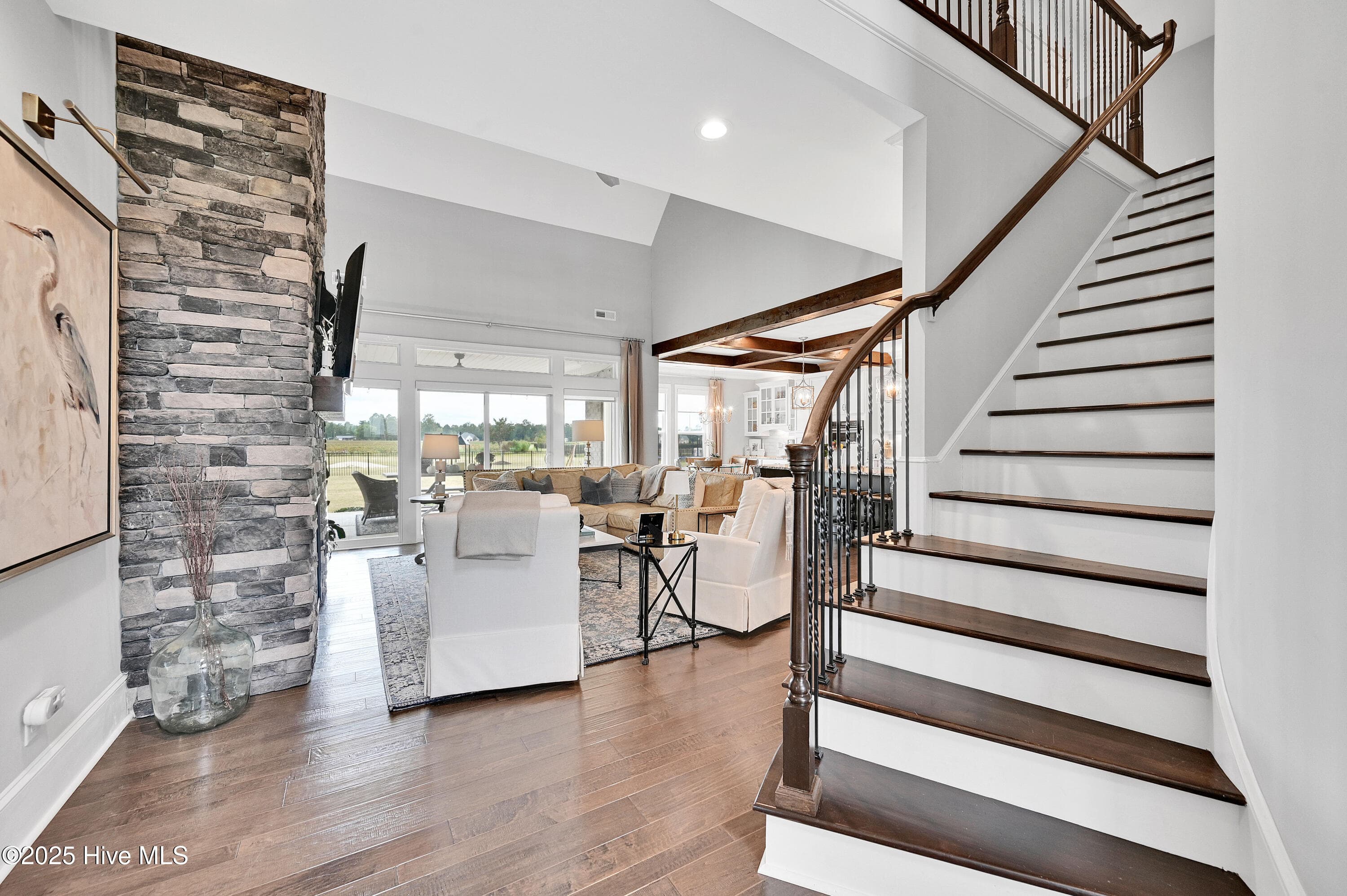 open stairway and stunning stone fireplace to the ceiling ! - 1357 Autumn Lakes Drive, Grimesland, NC 27837