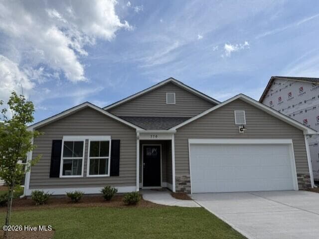 Homesite 301 is our Pebble floorplan with our traditional elevation and driftwood color scheme - 629 Pelican Cove Way SE 247, Southport, NC 28461