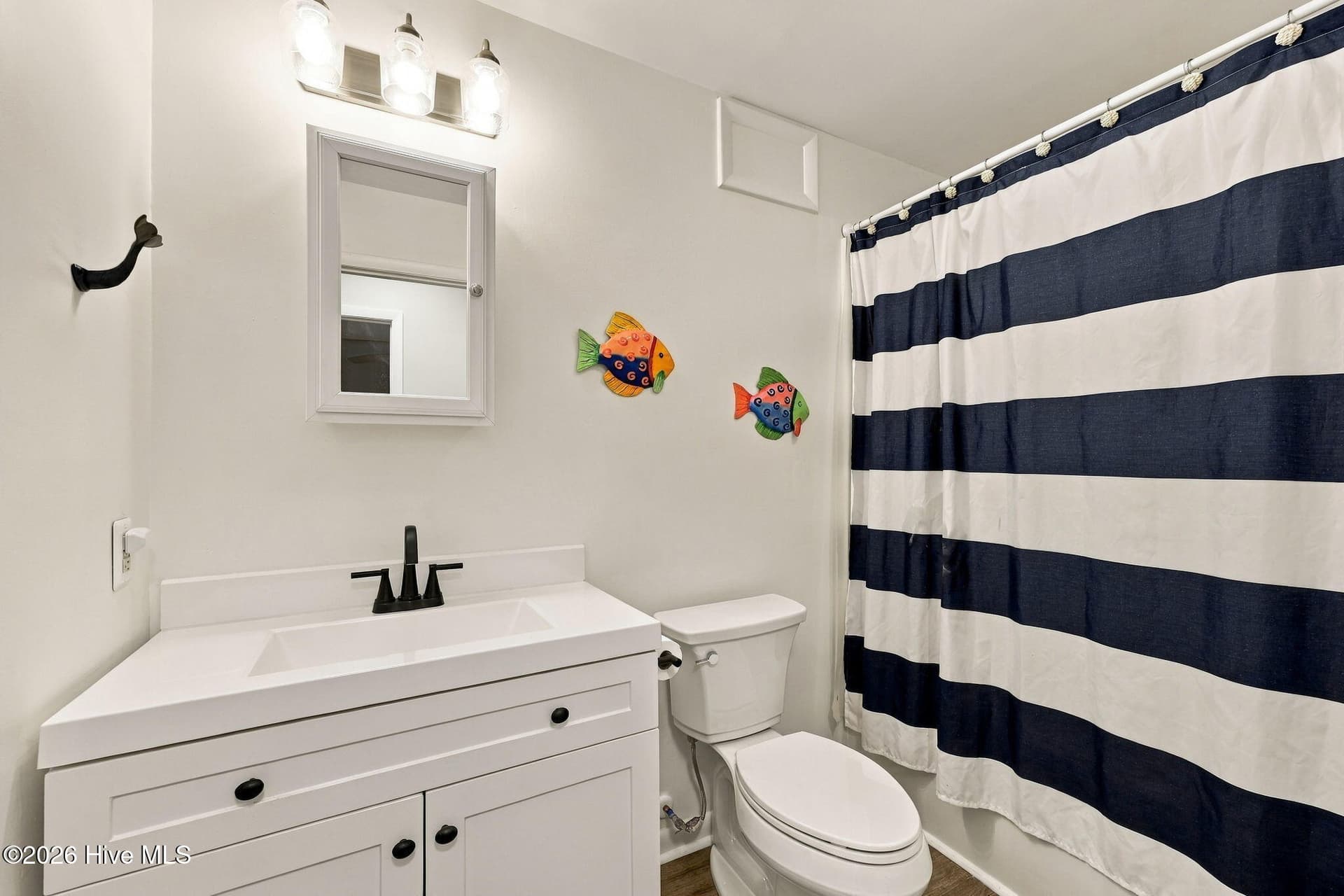 Hall bathroom has storage closet and washer dryer - 118 Periwinkle Drive, Emerald Isle, NC 28594
