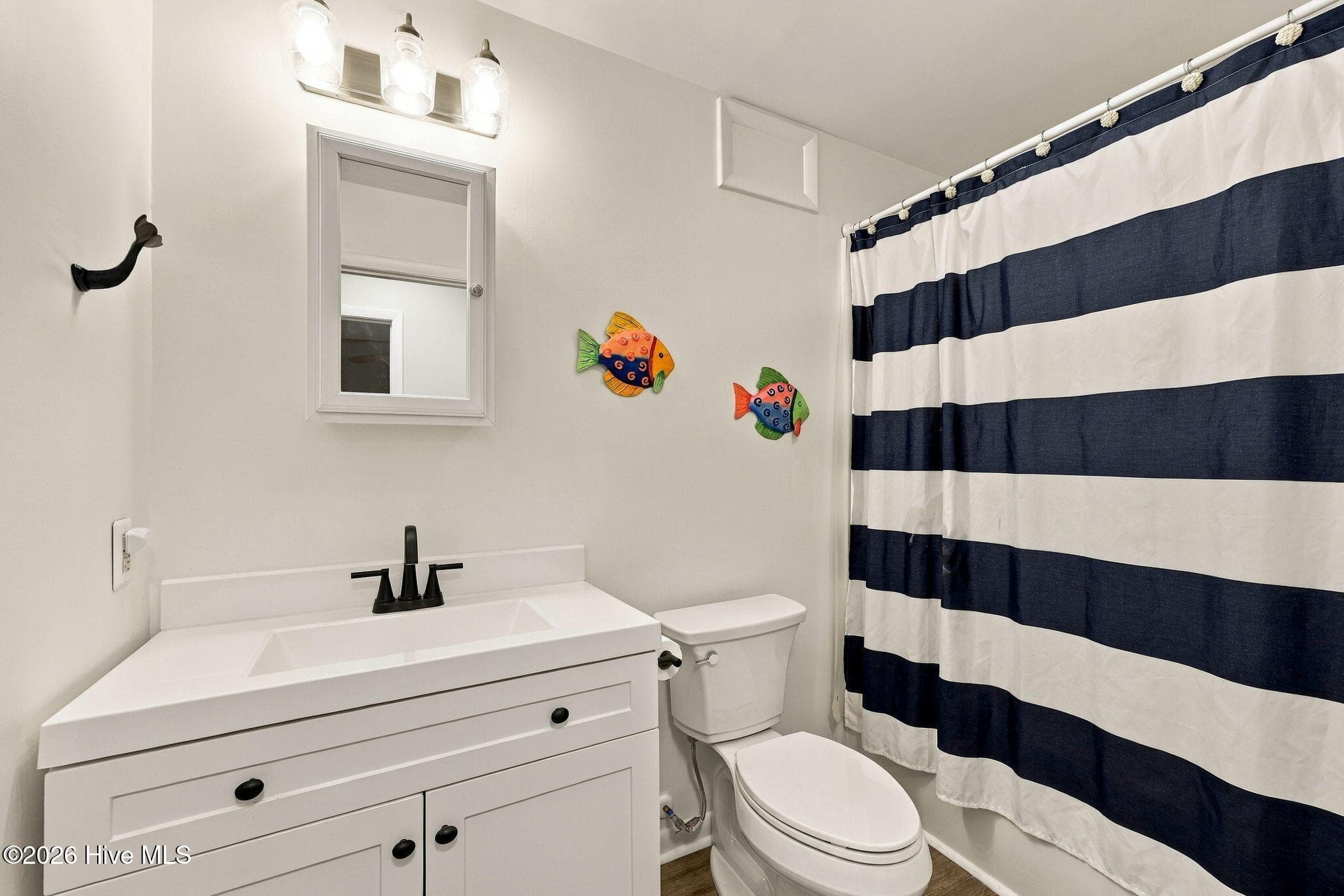 Hall bathroom has storage closet and washer dryer - 118 Periwinkle Drive, Emerald Isle, NC 28594