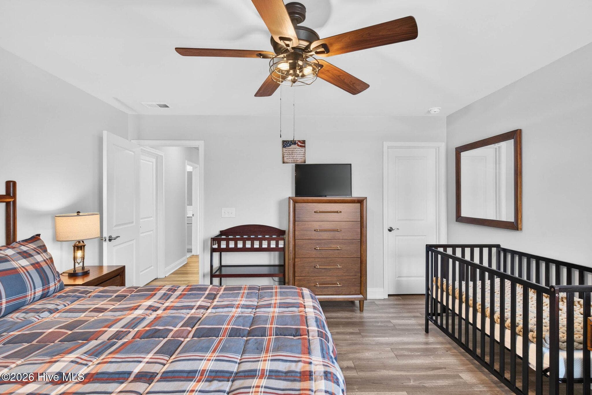 Another view highlights the bedroom’s generous size, ceiling fan, closet space, and flexible furniture arrangement. - 139 Eagle Claw Drive, Calabash, NC 28467