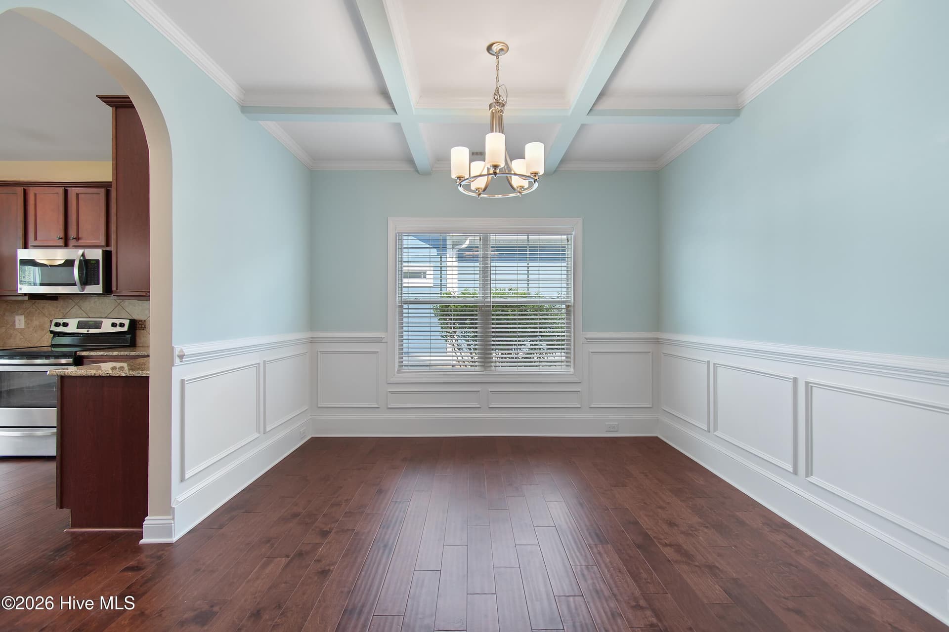 Dining room with coffered ceiling, wainscoting and beautiful natural light. - 1674 Back Bay Drive SW, Shallotte, NC 28470