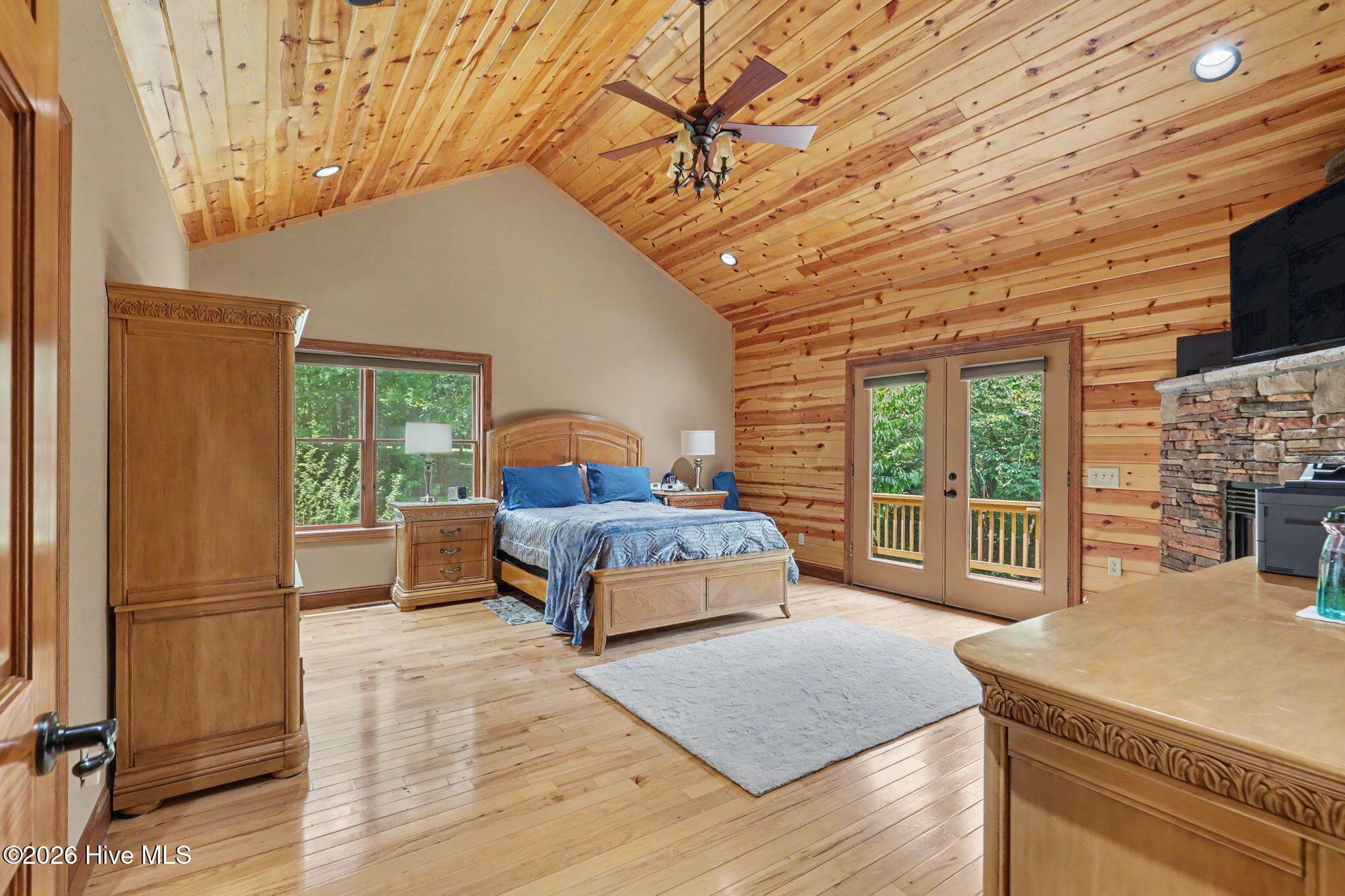 Spacious main-level primary suite with fireplace and private deck access. - 210 Majestic Drive, Hayesville, NC 28904