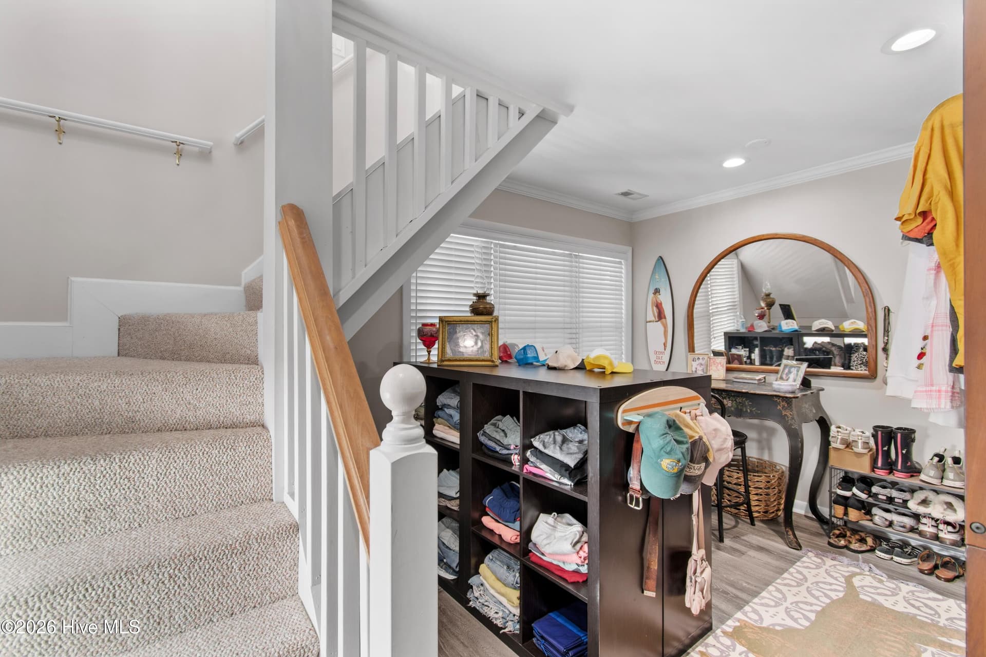 Large primary closet/dressing room with staircase to upstairs flex space. - 2024 Camelot Drive SW, Ocean Isle Beach, NC 28469