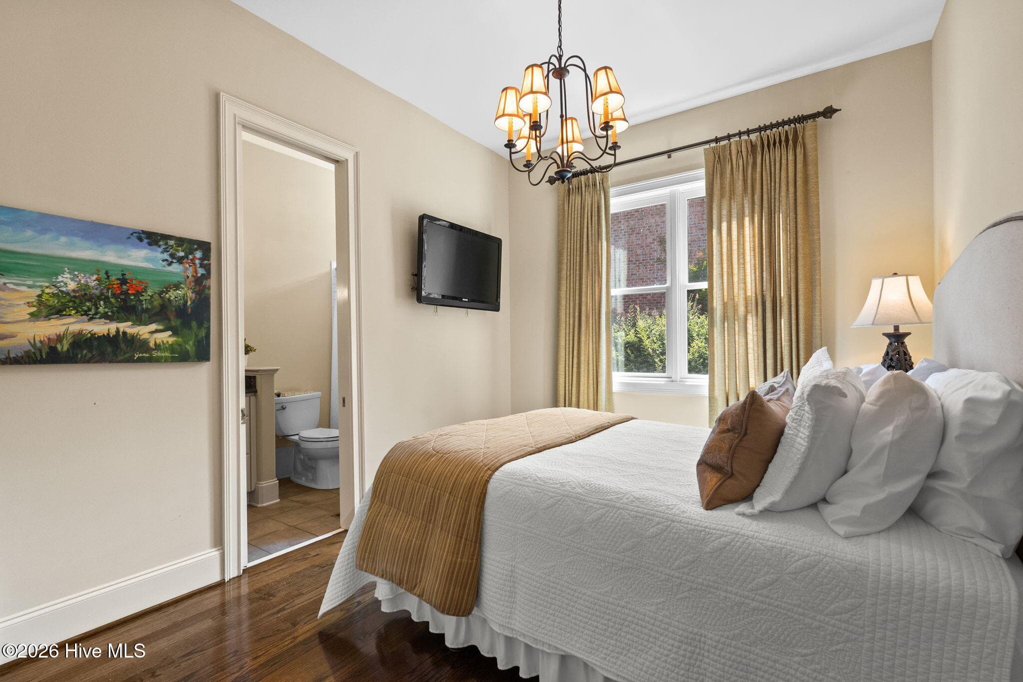 Guest bedroom with wood floors and ensuite - 3858 Ridge Crest Drive, Southport, NC 28461
