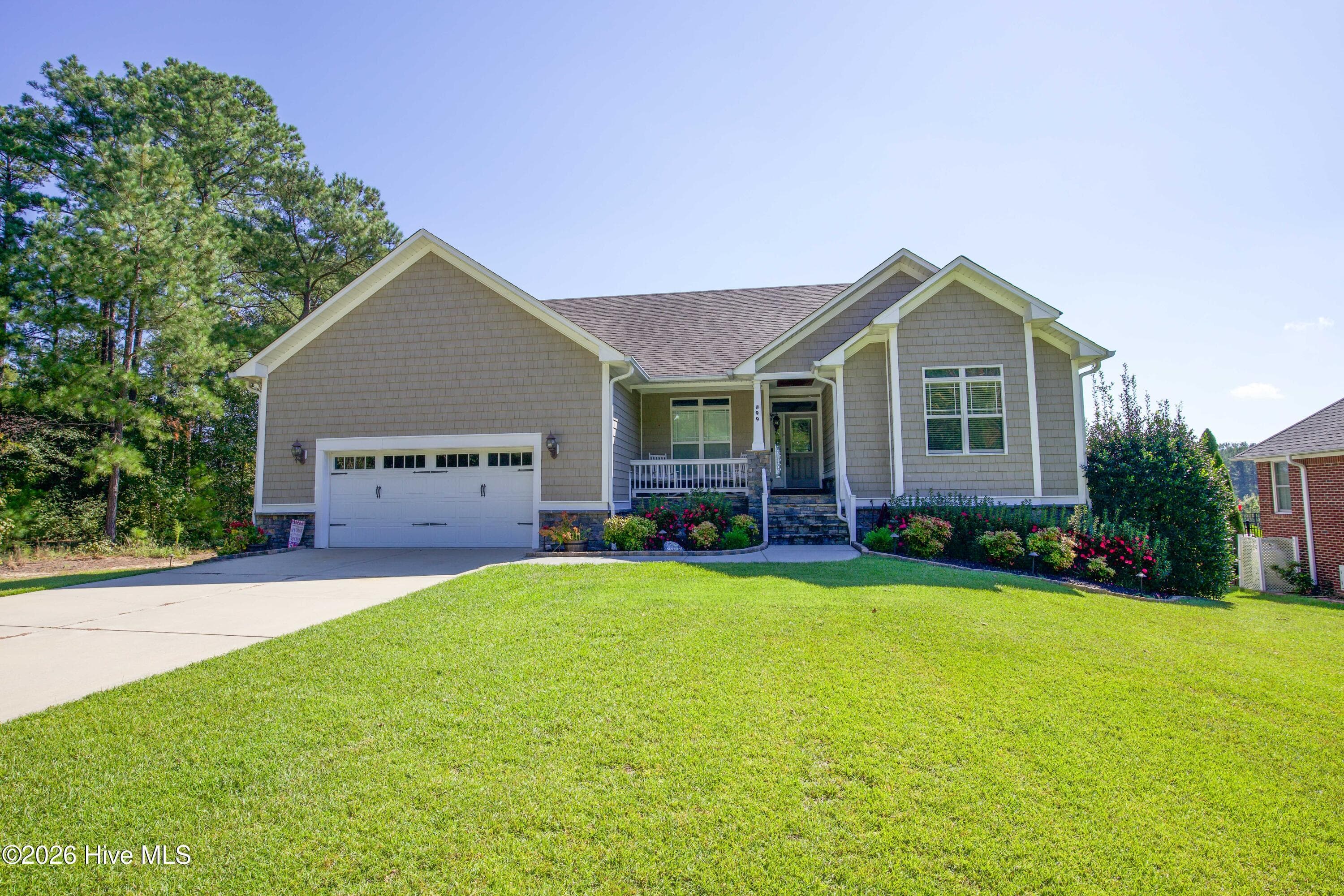 Another front view of 899 Seagull Drive with a stone-accented porch entry and landscaped beds, Woodlake, Vass NC. - 899 Seagull Drive, Vass, NC 28394, Vass