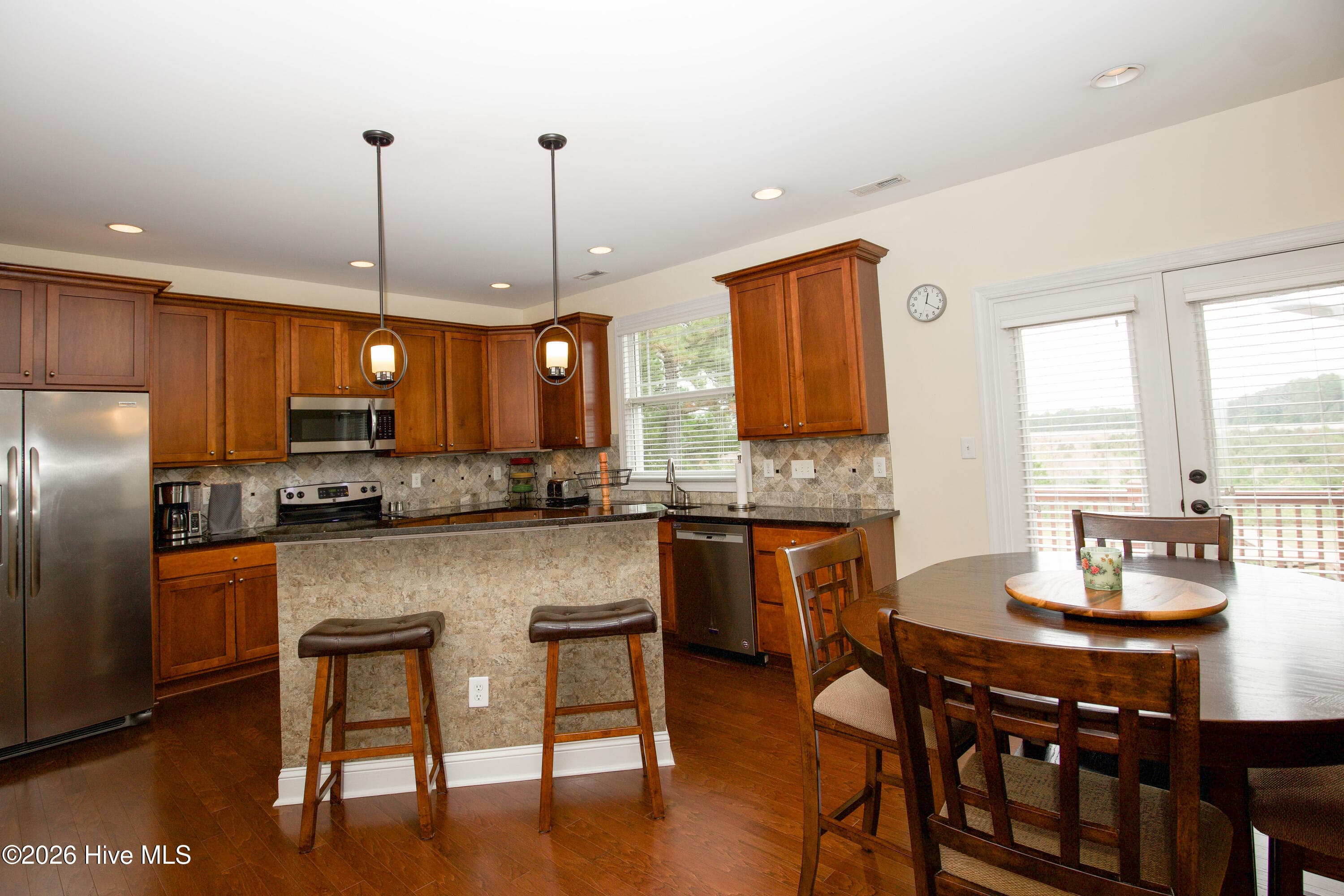 Kitchen island with seating, open to the breakfast area. - 899 Seagull Drive, Vass, NC 28394, Vass
