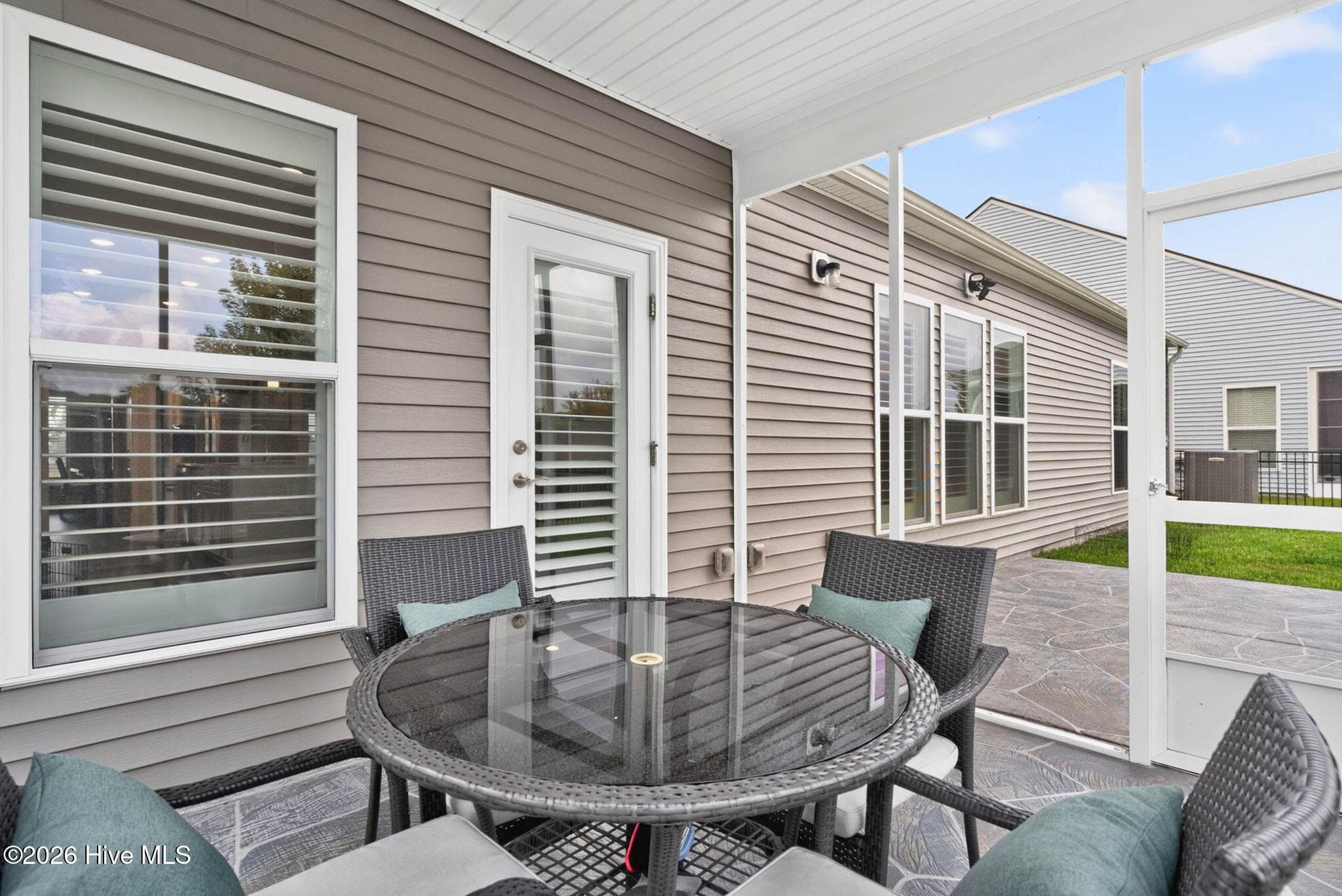 The screened porch extends the living space outdoors and provides a comfortable setting for dining, relaxing, and entertaining. - 139 Eagle Claw Drive, Calabash, NC 28467