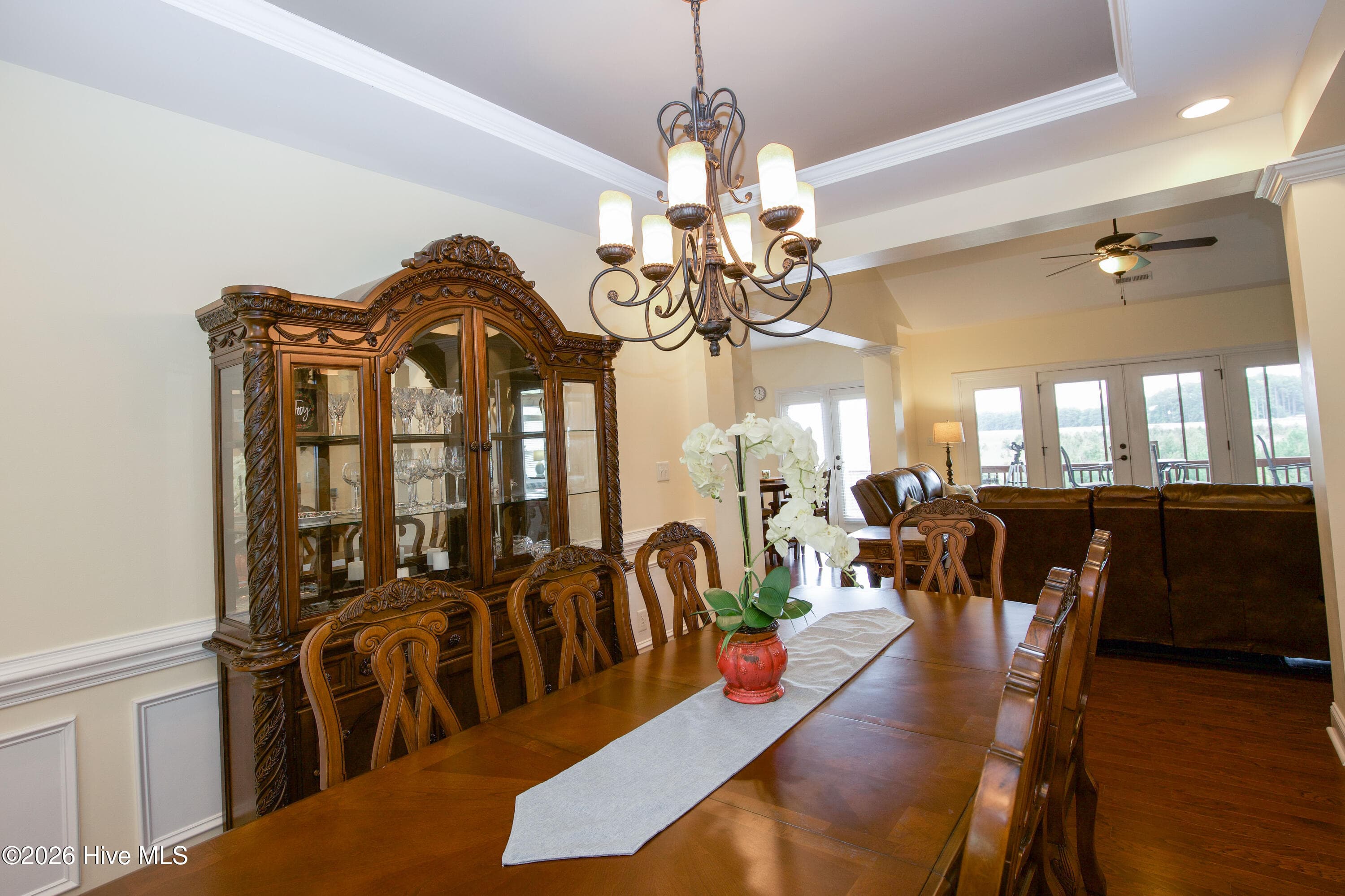 Dining room open to the living room, with French doors to the screened porch beyond. - 899 Seagull Drive, Vass, NC 28394, Vass