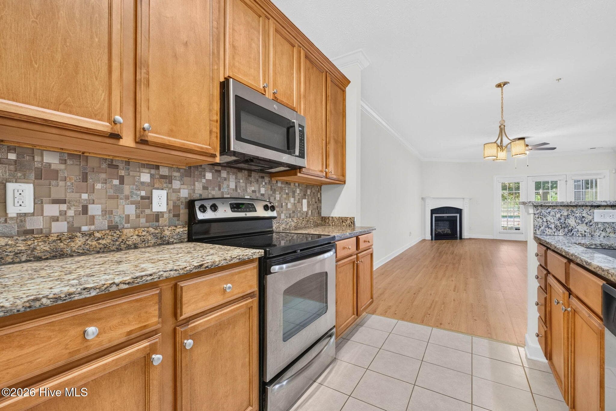 View of kitchen looking into the dining and then living area - 7825 High Market Street #303, Sunset Beach, NC 28468