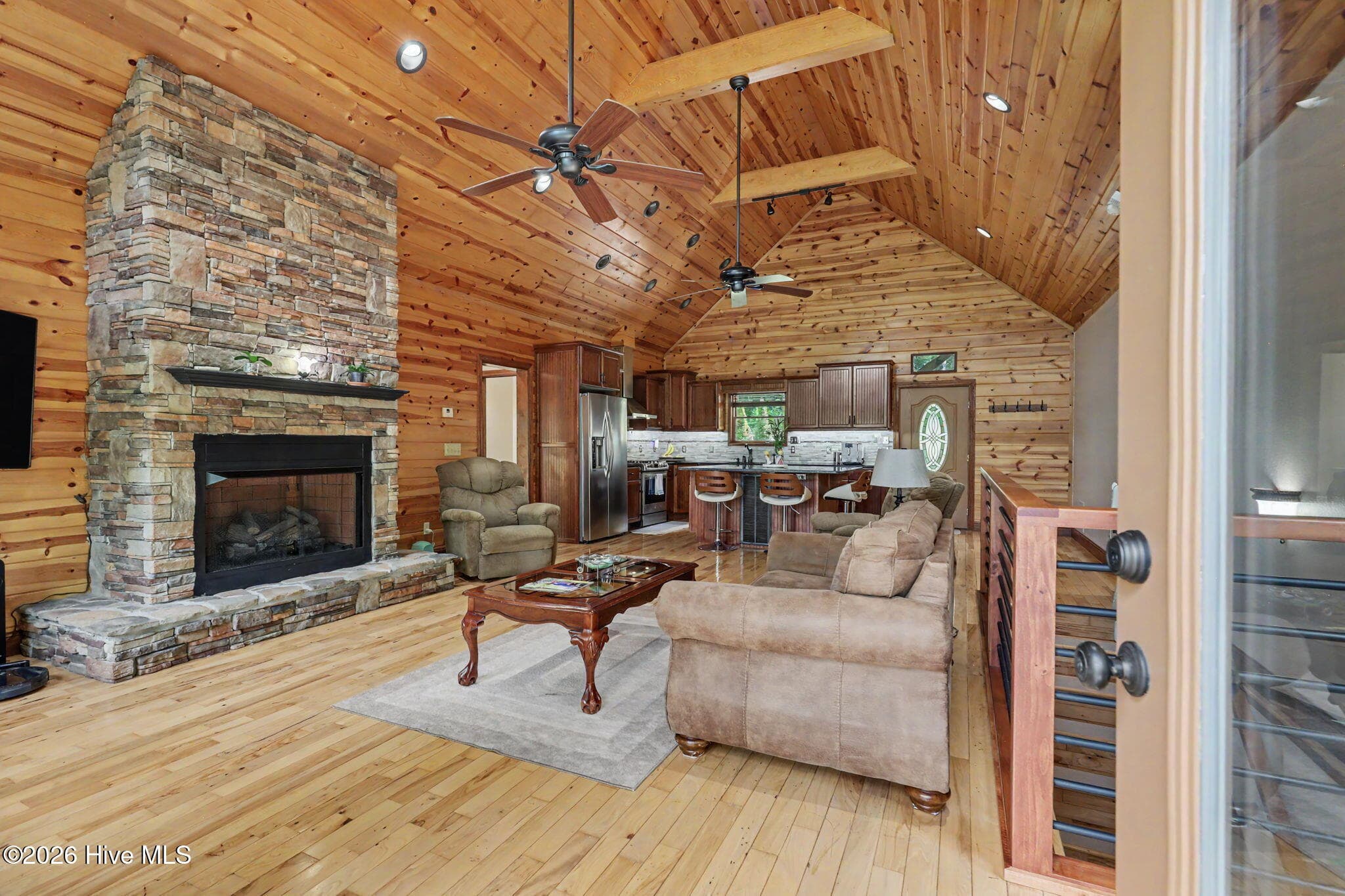 Floor-to-ceiling stacked stone fireplace anchors the spacious great room. - 210 Majestic Drive, Hayesville, NC 28904