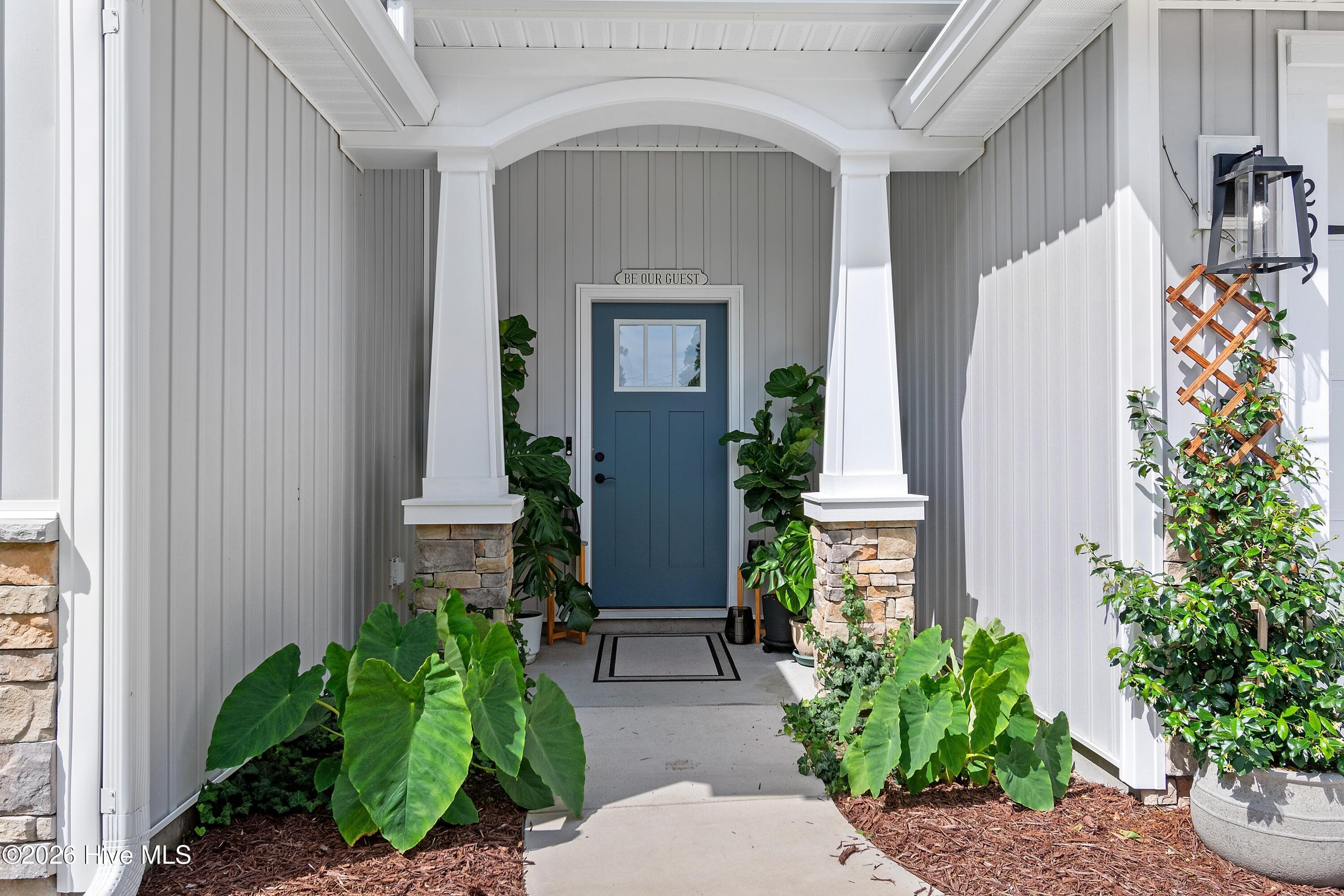 A covered front entrance creates a welcoming first impression while also providing a comfortable place to sit and relax. - 299 Boundaryline Drive NW, Calabash, NC 28467
