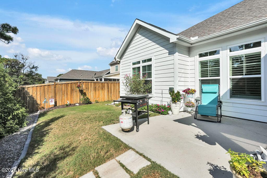 Take advantage of Wilmington’s greatest amenity, outdoor living, as you enjoy grilling, entertaining, or simply sunning on the extended patio. Relish the view from this prettily landscaped and irrigated lawn. If you hate to mow, this fenced backyard will be your favorite detail! - 142 Rice Marsh Way, Wilmington, NC 28412