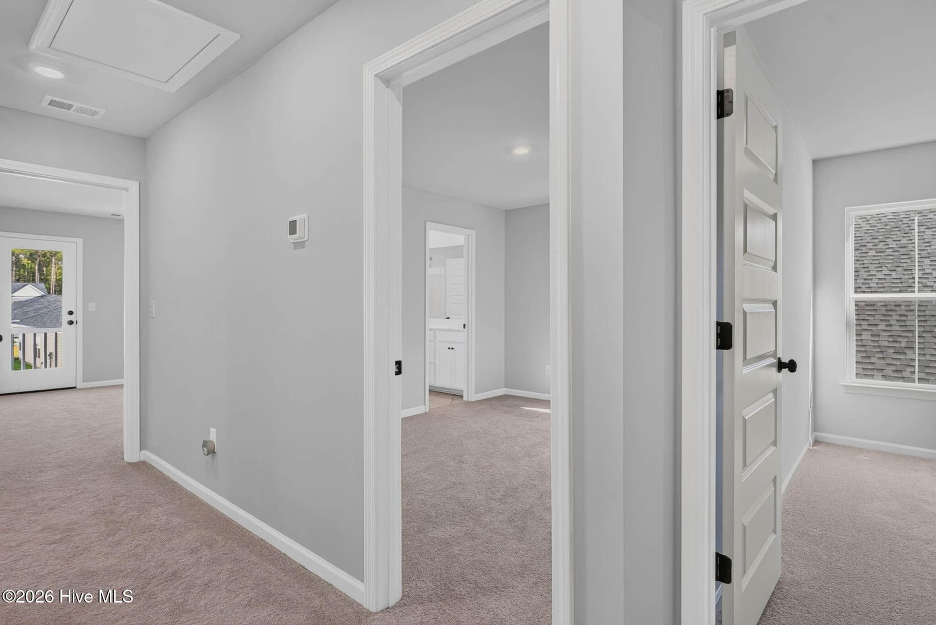 Upstairs hallway connecting the secondary bedrooms and guest accommodations. - 3447 Sandhill Crane Drive SW, Ocean Isle Beach, NC 28469