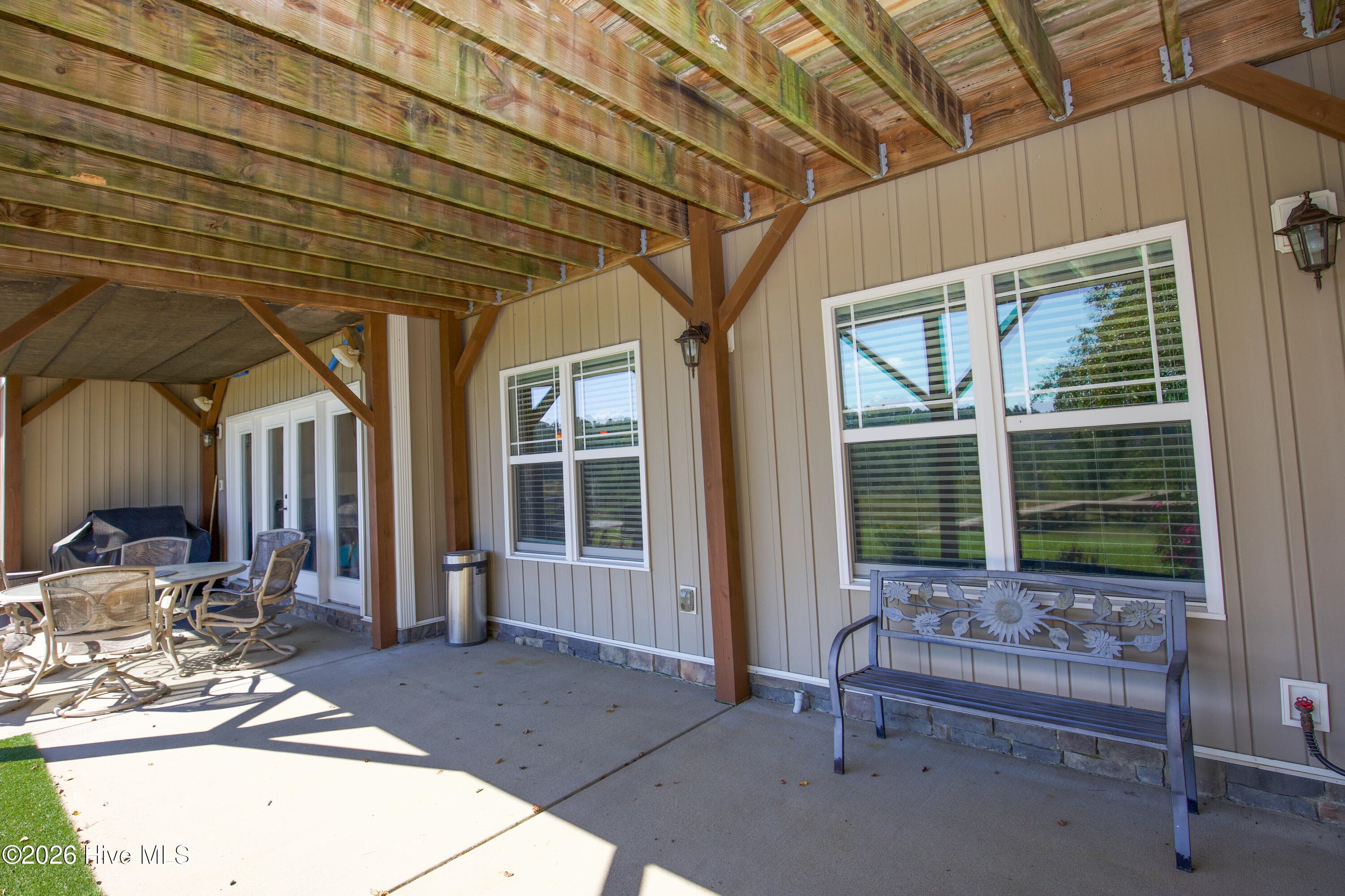 Covered lower-level patio with a walkout entry at the back of 899 Seagull Drive, Woodlake, Vass NC. - 899 Seagull Drive, Vass, NC 28394, Vass