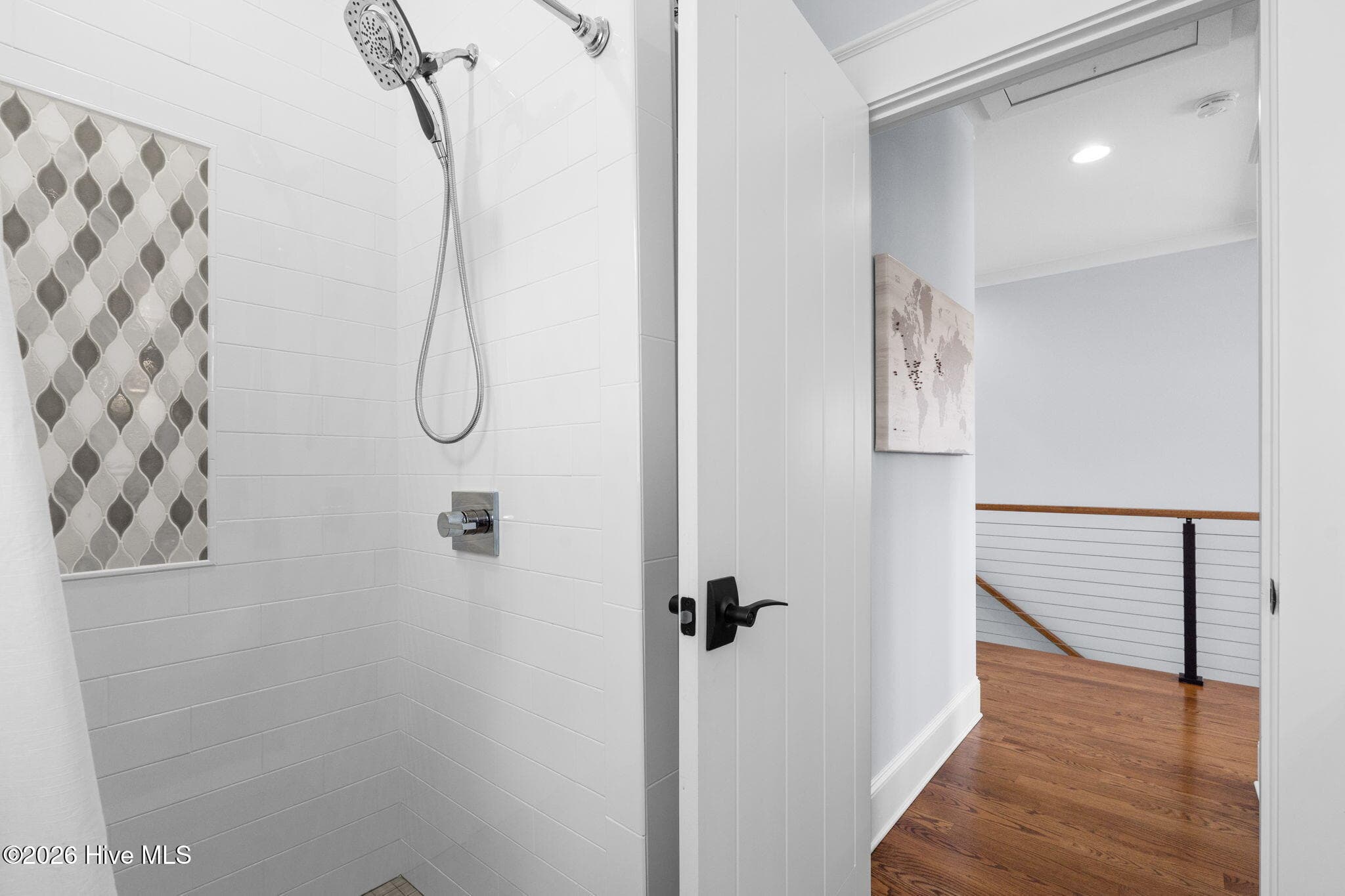 Tiled shower with linen storage behind the door - 2775 Long Bay Drive SE, Southport, NC 28461