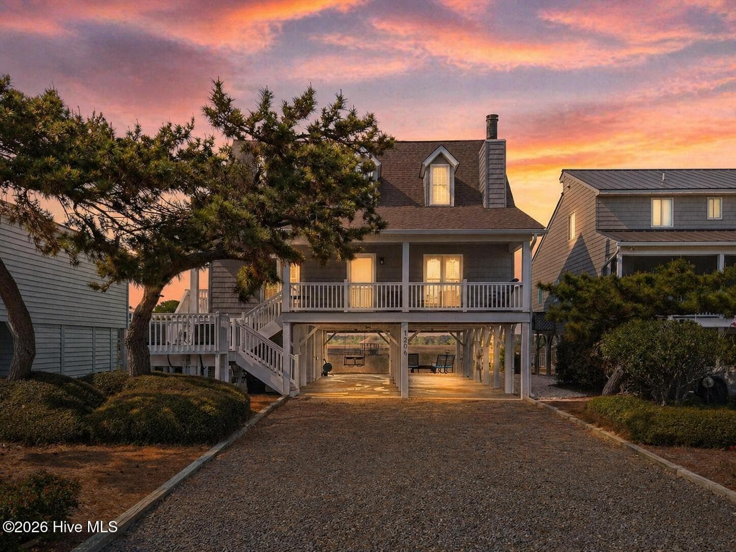 Twilight photo of the front exterior of 1206 N Shore Drive W. - 1206 N Shore Drive W, Sunset Beach, NC 28468