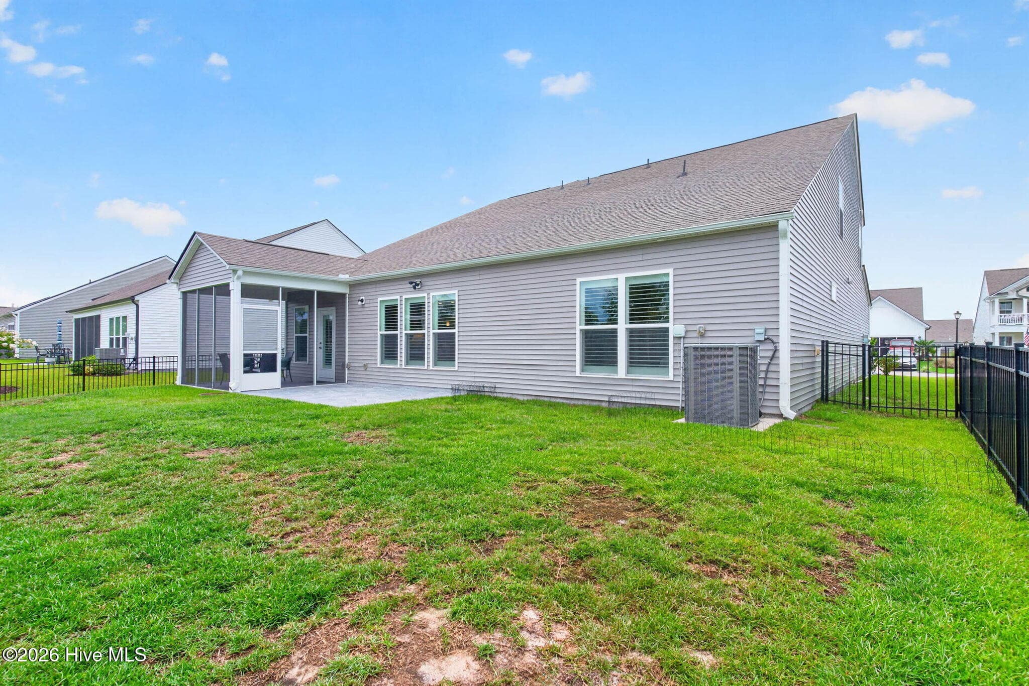 Another view of the backyard showcases the home’s generous outdoor space and low-maintenance vinyl siding. - 139 Eagle Claw Drive, Calabash, NC 28467