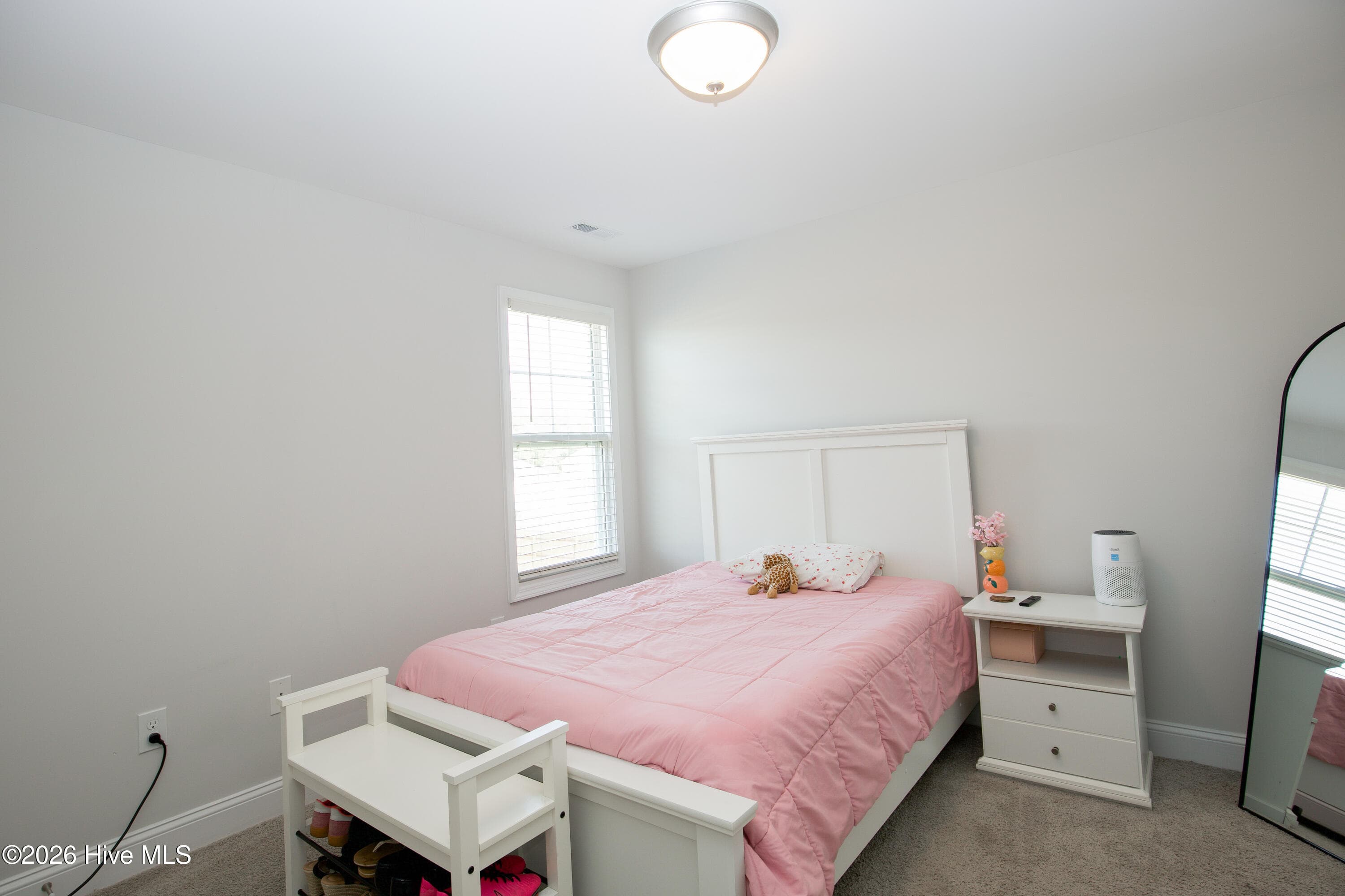 The fourth bedroom offers carpet, a ceiling light, and a window that brings in natural light. There is room for a full or queen bed with nightstands. Having a fourth bedroom gives you space that could also work as a guest room or upstairs office. - 221 Vega Lane, Linden, NC 28356