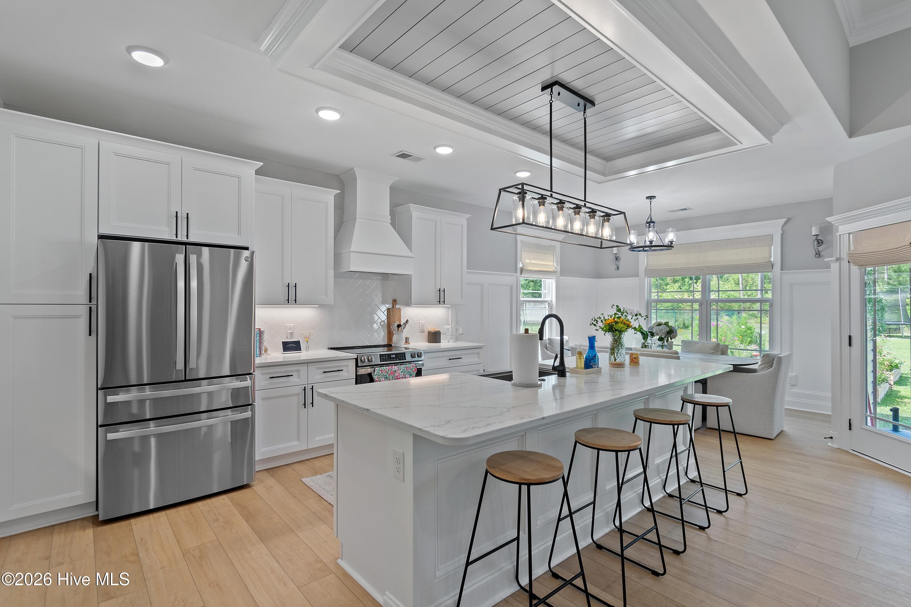 High ceilings throughout the kitchen and living room. Large center island with bar seating and recessed lighting. Stainless steel appliances in the kitchen. - 299 Boundaryline Drive NW, Calabash, NC 28467