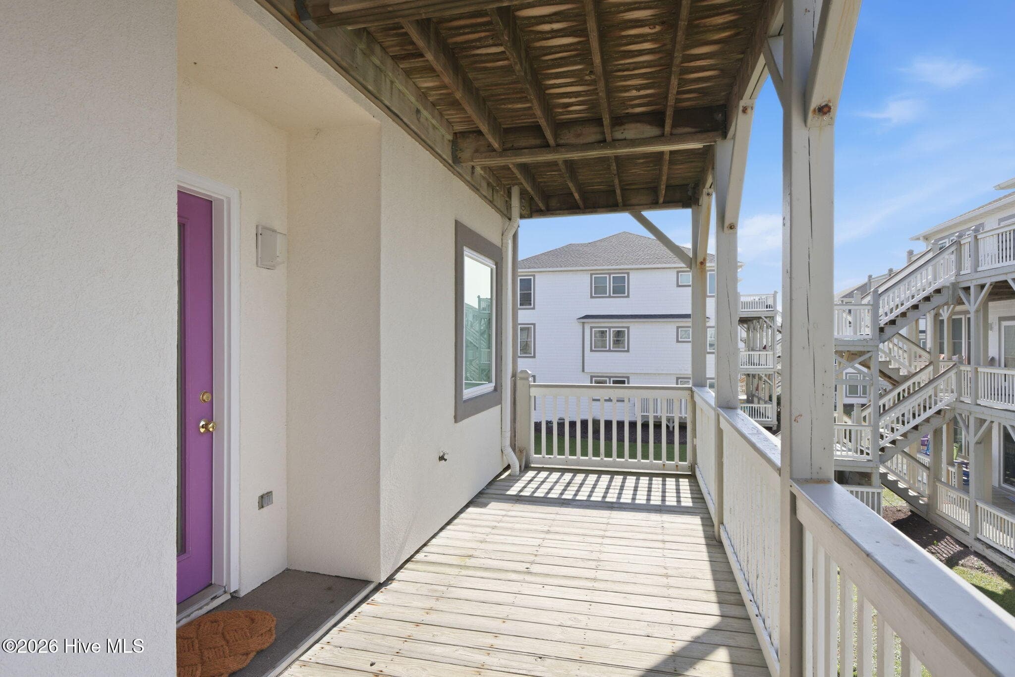Front door and covered deck facing sound. - 2801 Pier Pointe Drive B2, Emerald Isle, NC 28594