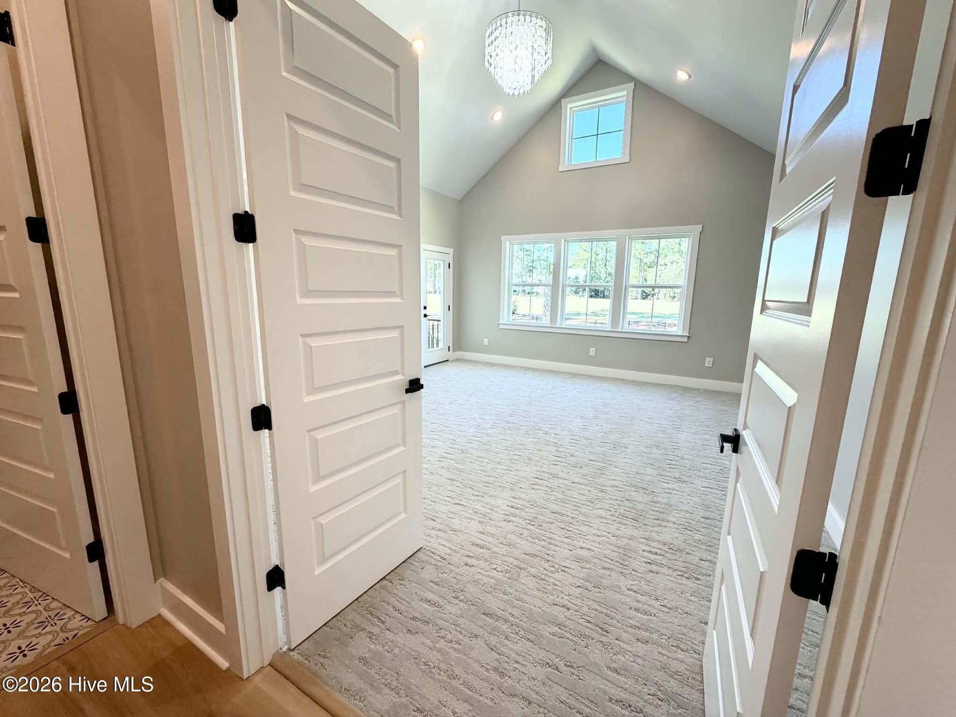 Primary suite with custom lighting, private porch, ensuite bath, walk in closet and custom high end carpeting. - 550 Glenburnie Street NW, Calabash, NC 28467