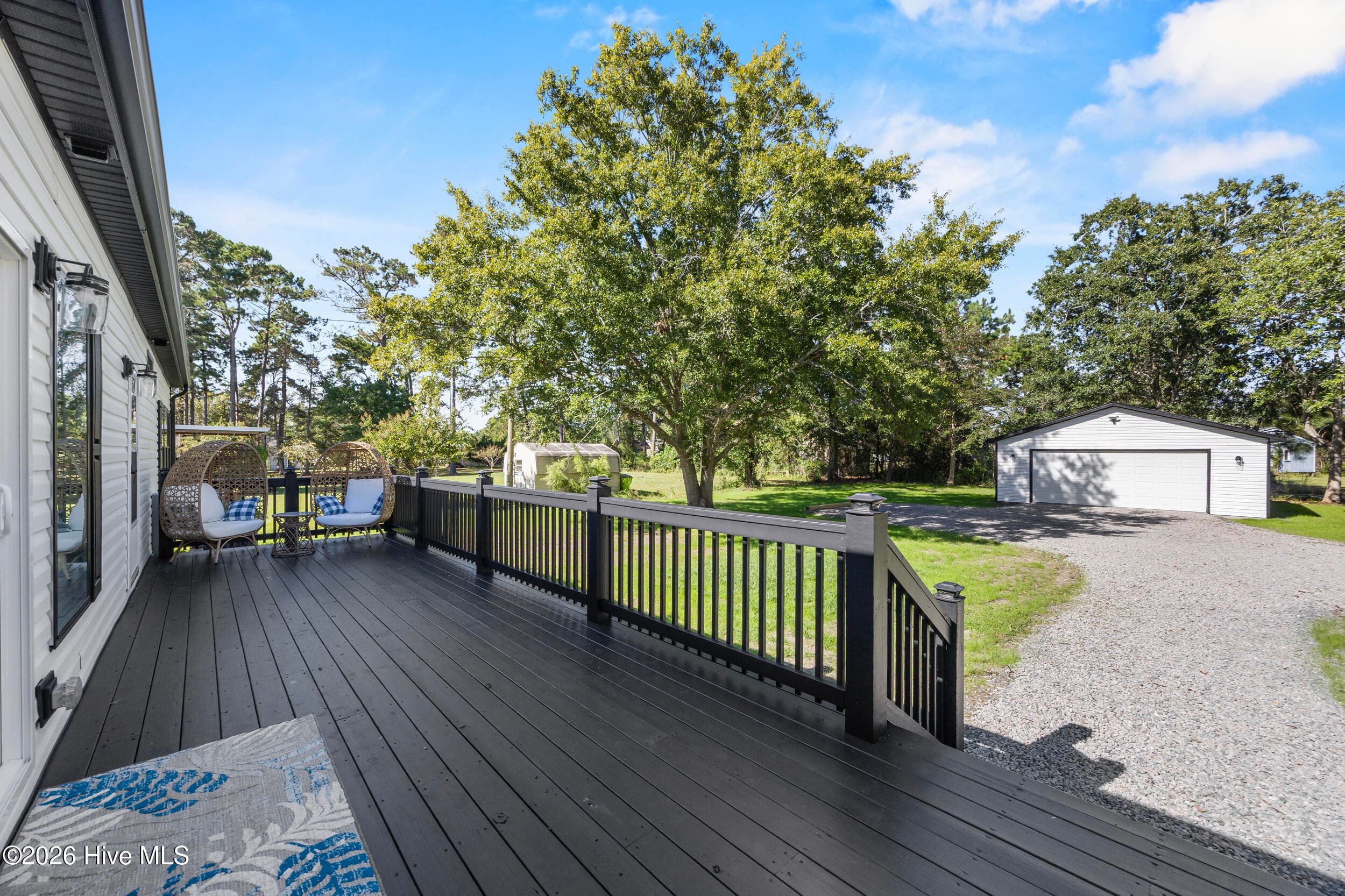 Expansive rear deck offers the perfect setting for outdoor entertaining, grilling, or simply relaxing while overlooking the spacious backyard. Enjoy the added convenience of a detached garage/workshop and plenty of room to enjoy the outdoors - 771 Factory Road, Hampstead, NC 28443