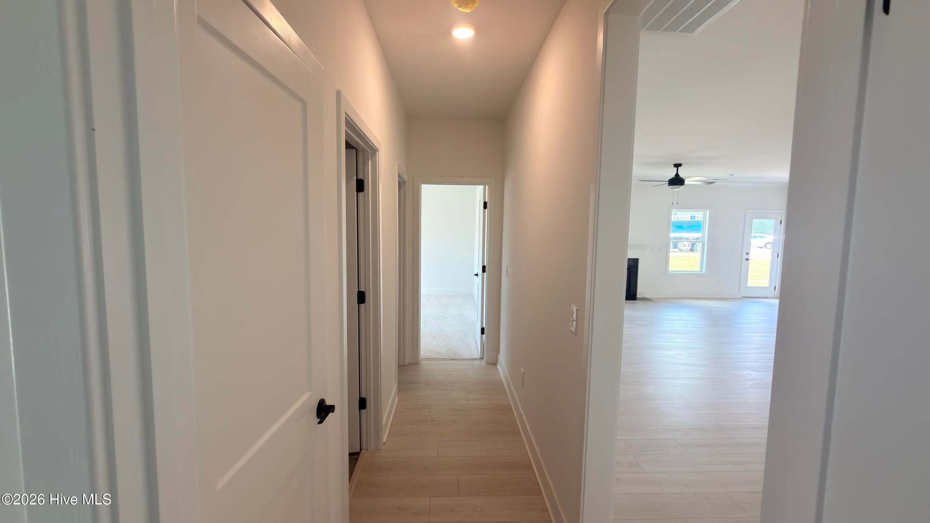 Hallway with bedrooms 2 and 3, laundry room, and full bath - 2129 Sandbrook Loop, Leland, NC 28451
