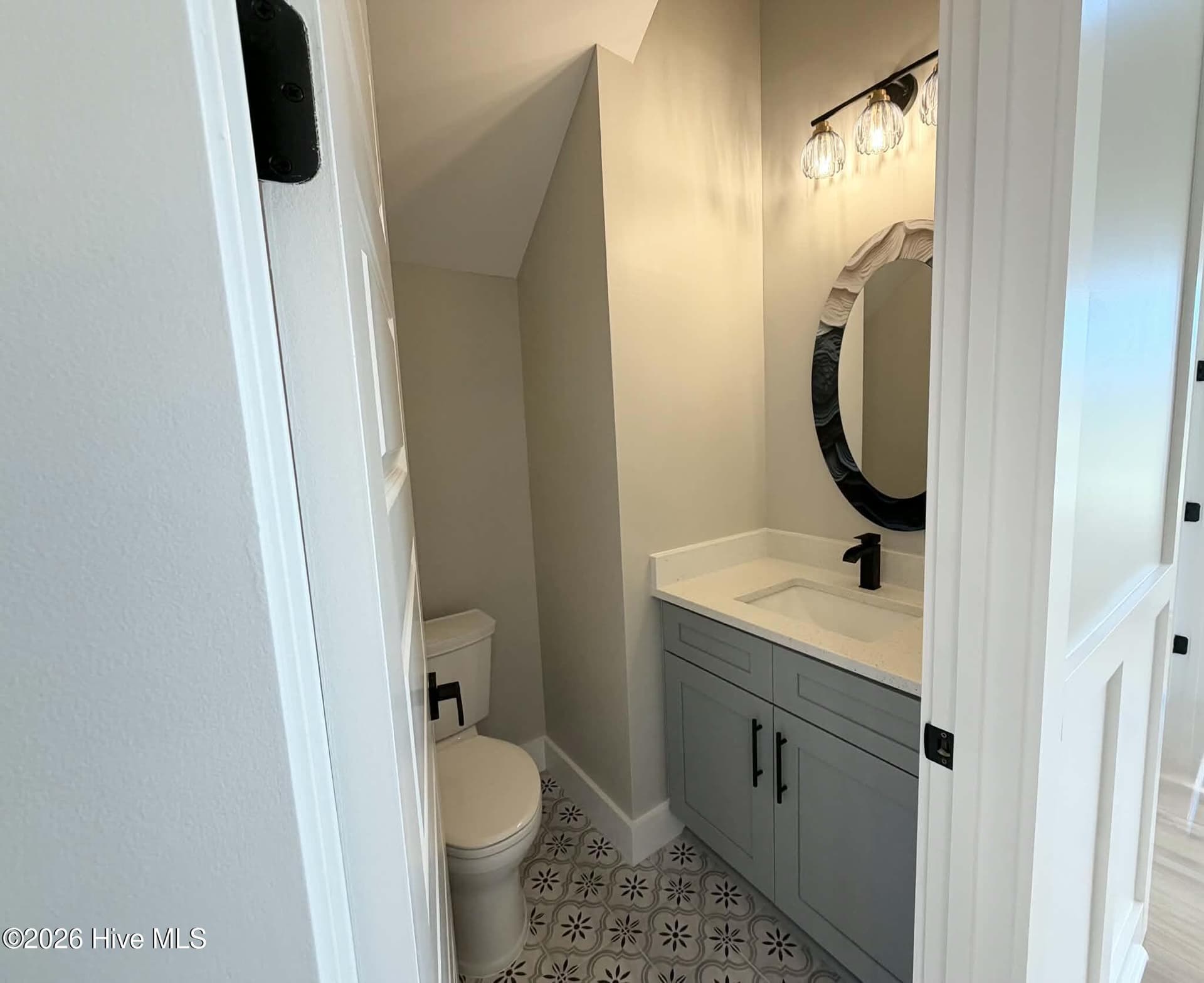 Powder room half bath, custom mirror and lighting. - 550 Glenburnie Street NW, Calabash, NC 28467