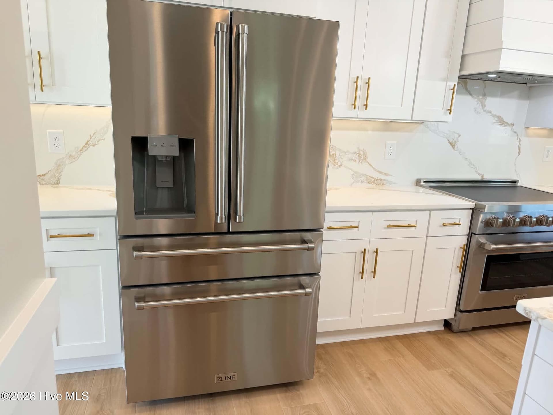 Kitchen area. Custom lighting, counter tops, backsplash, faucet and cabinet hardware. Upgraded induction range. - 550 Glenburnie Street NW, Calabash, NC 28467