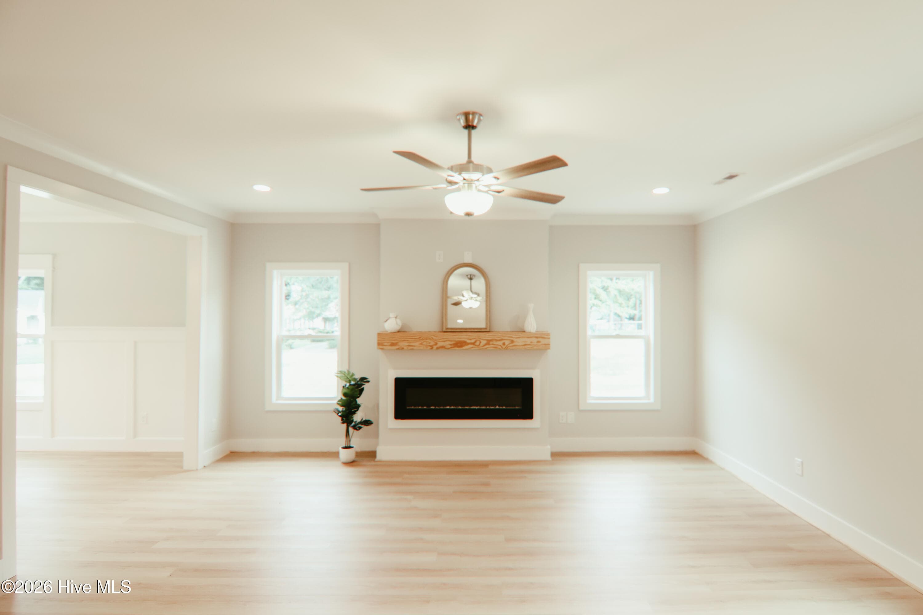 Family room with ceiling fan, can lights, electric fireplace with a floating mantel - 223 Glenwood Trail, Goldsboro, NC 27534