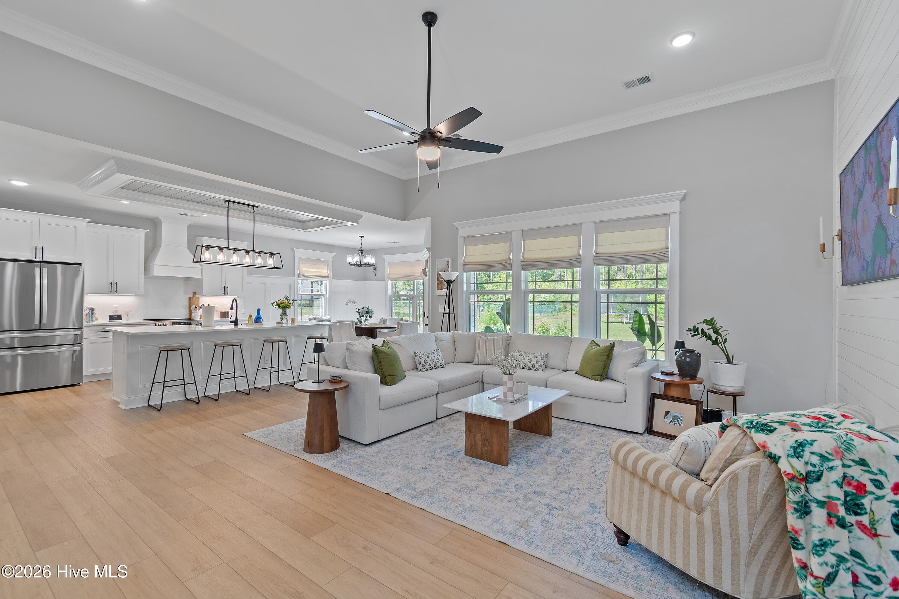 An open and airy feel, the living room and kitchen offer a spacious feel and high end finishes. - 299 Boundaryline Drive NW, Calabash, NC 28467