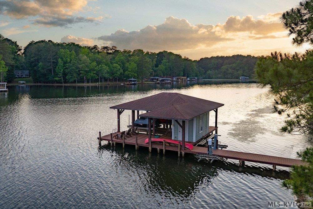 Serene Lake Life, Whether you're launching for a sunrise paddle or watching the sky turn to gold from your boathouse retreat, this is where 'lake time' truly begins. - 381 West Bend Dr., Gasburg VA 23857, Gasburg