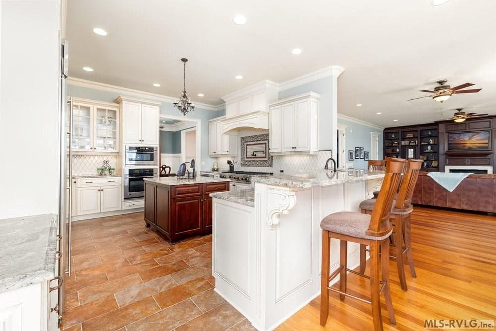 Kitchen, The spacious, sunlit kitchen is a chef’s delight, effortlessly combining style and functionality. Its open design flows naturally into a casual breakfast bar seating area, ideal for both entertaining - 381 West Bend Dr., Gasburg VA 23857, Gasburg