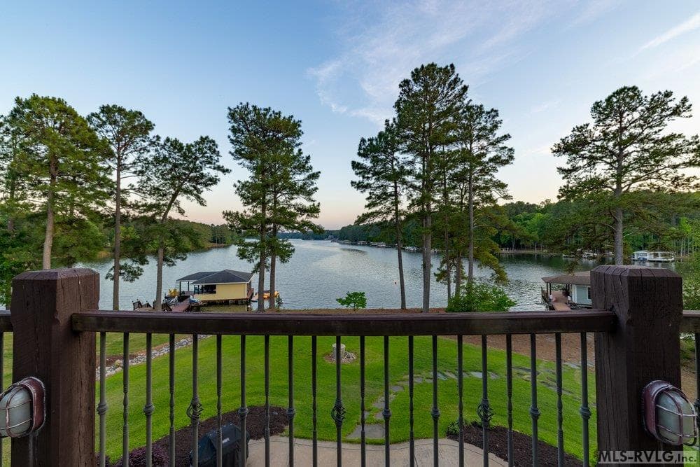 Classic Charm Meets Waterfront Elegance, Large, multi-level balconies and a private dock for sunset views. - 381 West Bend Dr., Gasburg VA 23857, Gasburg