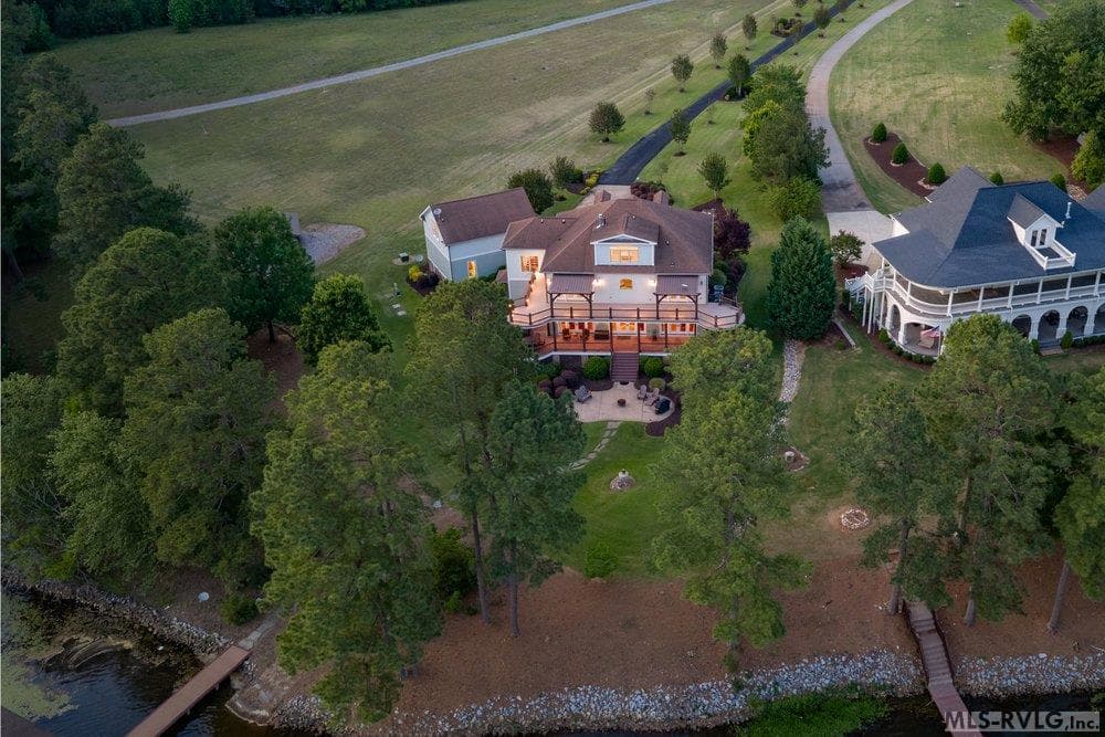 Expanded Lakeside Luxury, This property comes with an extra open lot right next to the main house. Keep it as a huge yard for maximum privacy, or use the space to build. It’s an ideal spot for a guest house, a private pool. - 381 West Bend Dr., Gasburg VA 23857, Gasburg