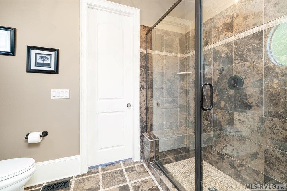 Sophisticated Custom-Tiled Walk-in Shower , Sleek frameless glass enclosure and dramatic, large-format stone tile. - 381 West Bend Dr., Gasburg VA 23857, Gasburg