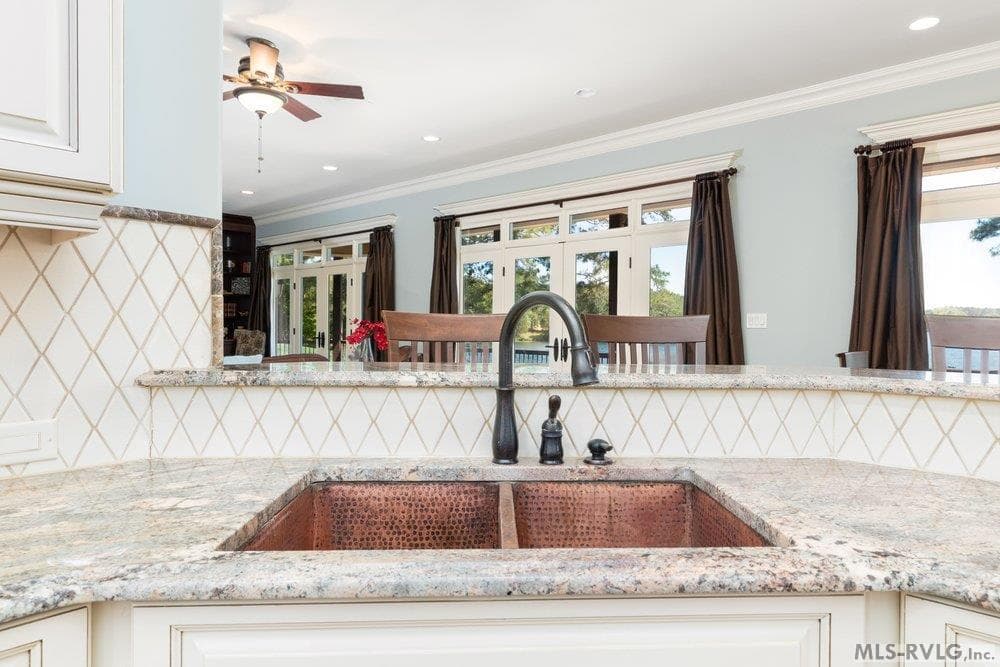 Double-Basin Hammered Copper Sink, Paired with elegant stone countertops and a modern gooseneck faucet and with a view - 381 West Bend Dr., Gasburg VA 23857, Gasburg