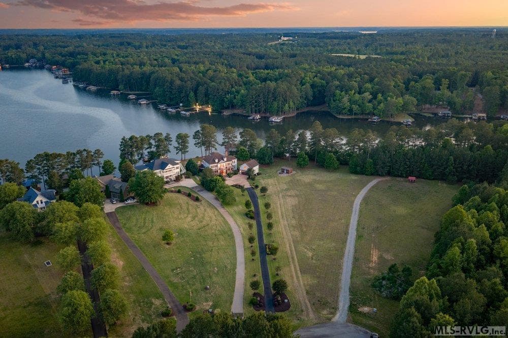 Sprawling Estate, Where land meets the serene waters of a tranquil cove. A sanctuary designed for those who value privacy and a deep connection to nature. - 381 West Bend Dr., Gasburg VA 23857, Gasburg