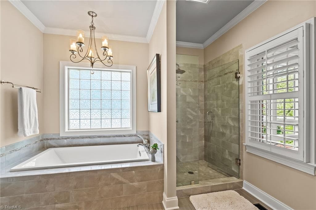 Soaking tub and walk in tiled shower with glass block window and plantation shutters for privacy - 11555 Double Spring Road, Lewisville NC 27023, Lewisville
