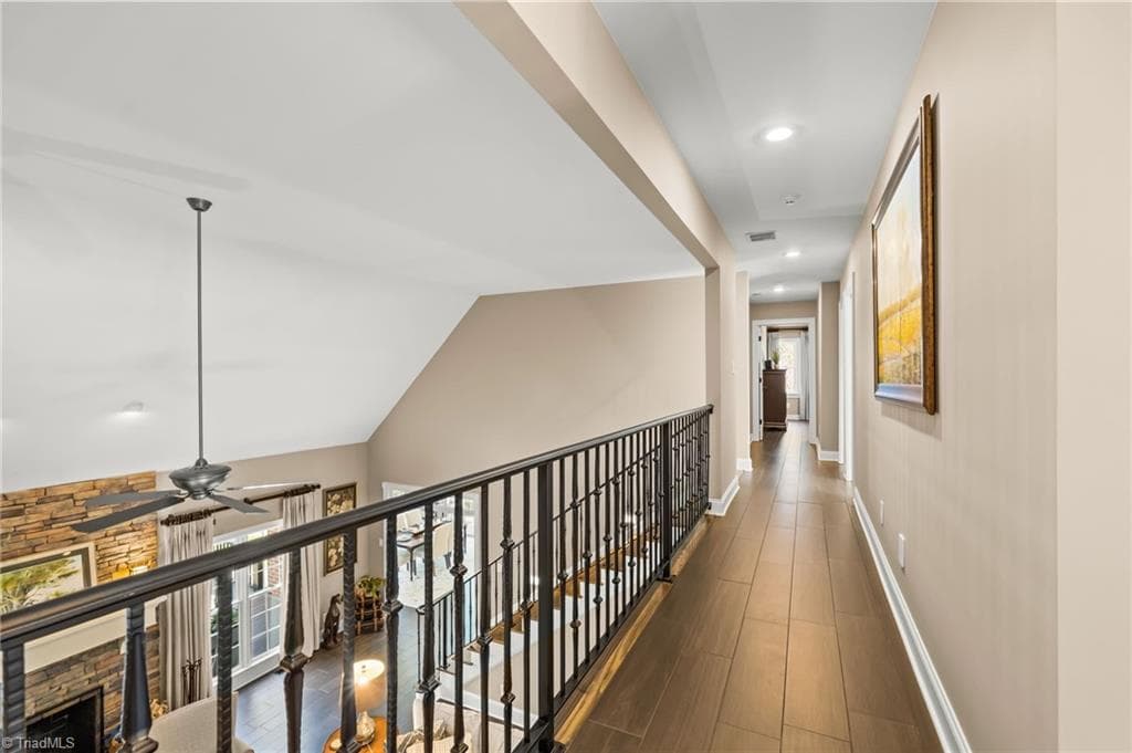 The custom iron railing is a stand out feature overlooking the great room. - 11555 Double Spring Road, Lewisville NC 27023, Lewisville